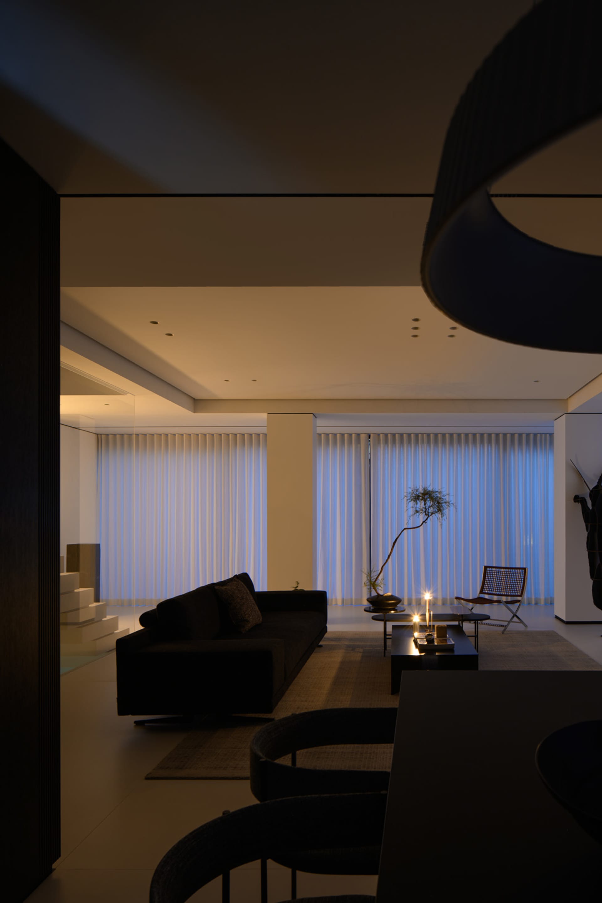 A modern living room with textured curtains and ceiling.