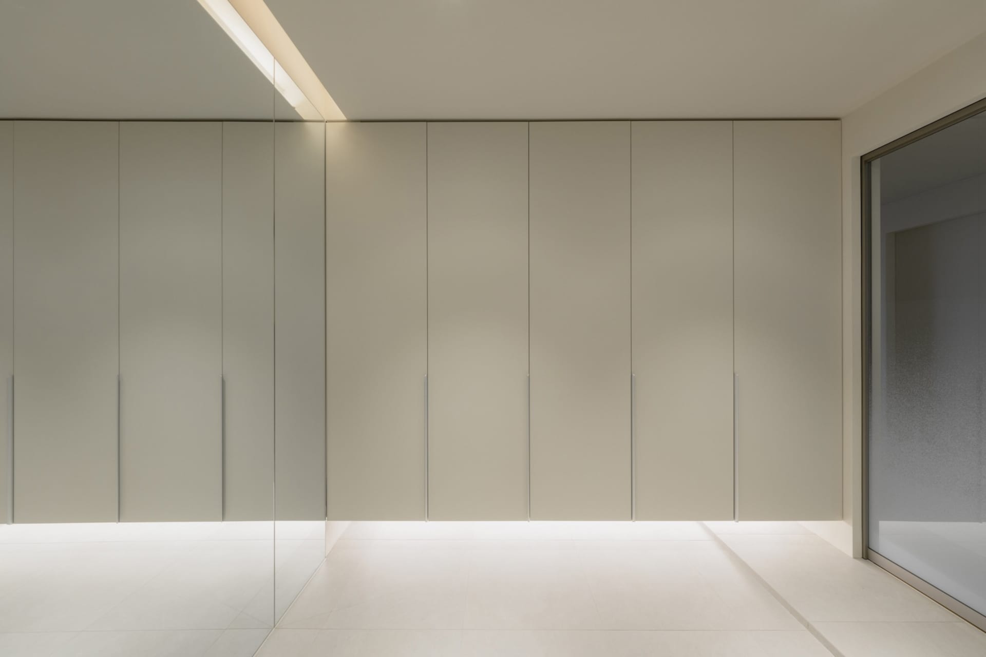Modern minimalist metal closet system with white cabinets and sleek, minimalist design.