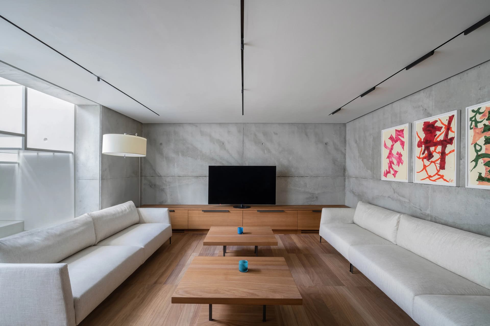 Industrial-style living room featuring concrete and wood materials.