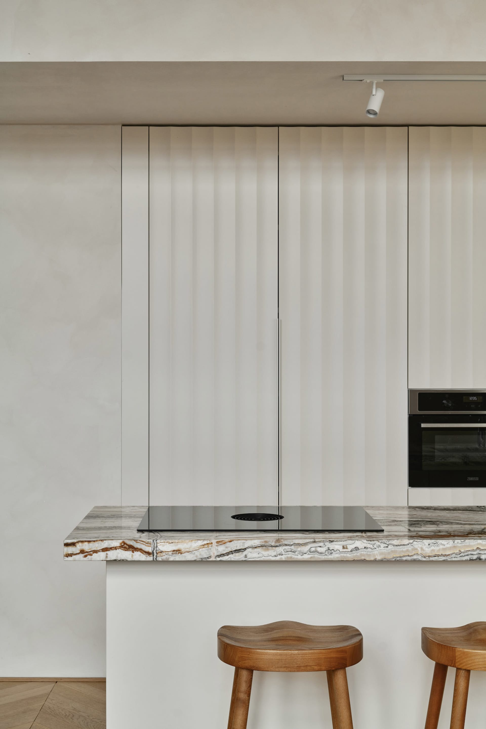 A modern kitchen with a marble countertop and minimalist design.