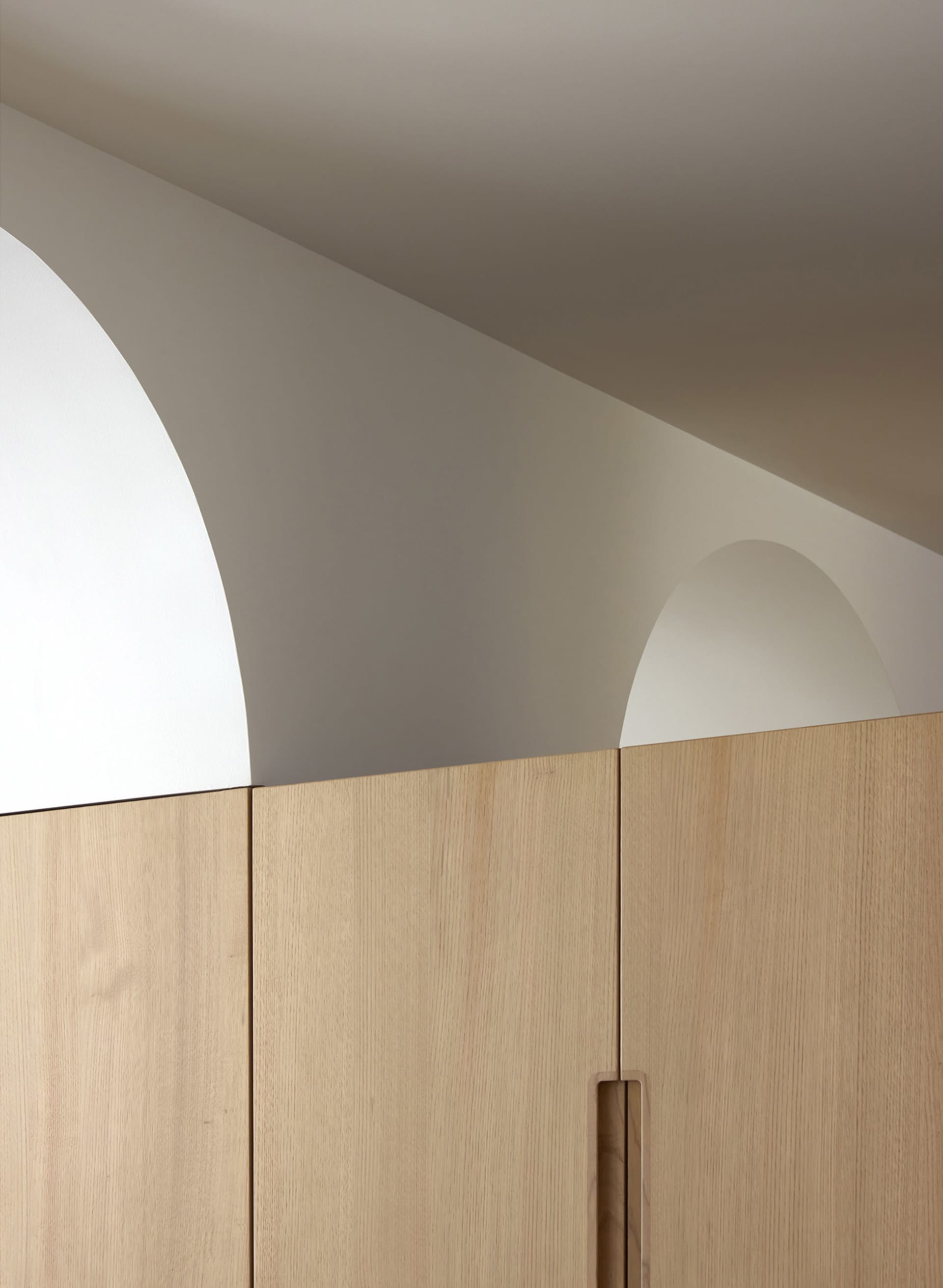 A close-up view of minimalist wooden moldings with light-colored wood in a minimalist setting.