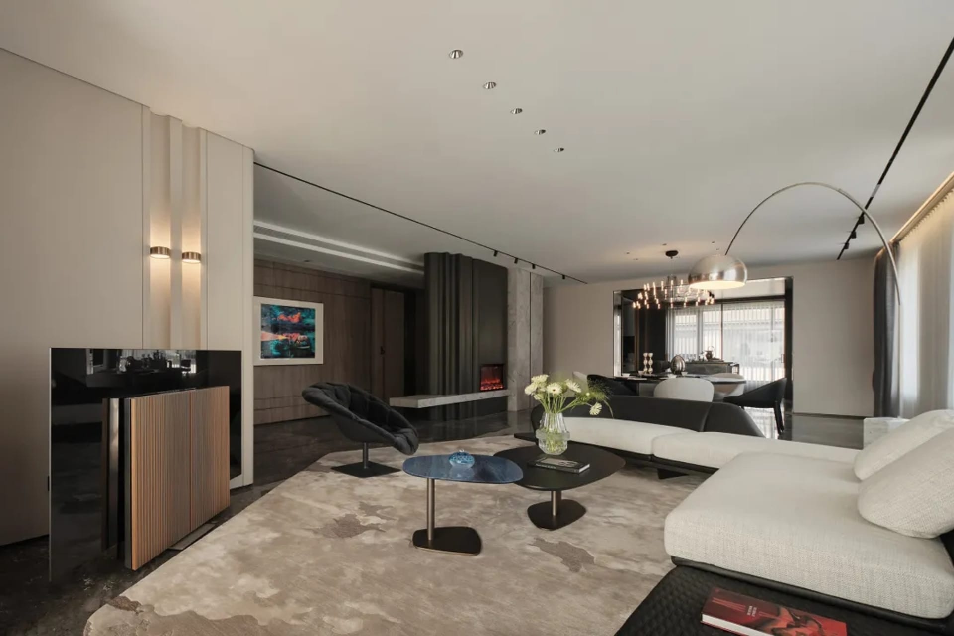 Modern living room with white furniture, dark wood floor, and minimalist decor.