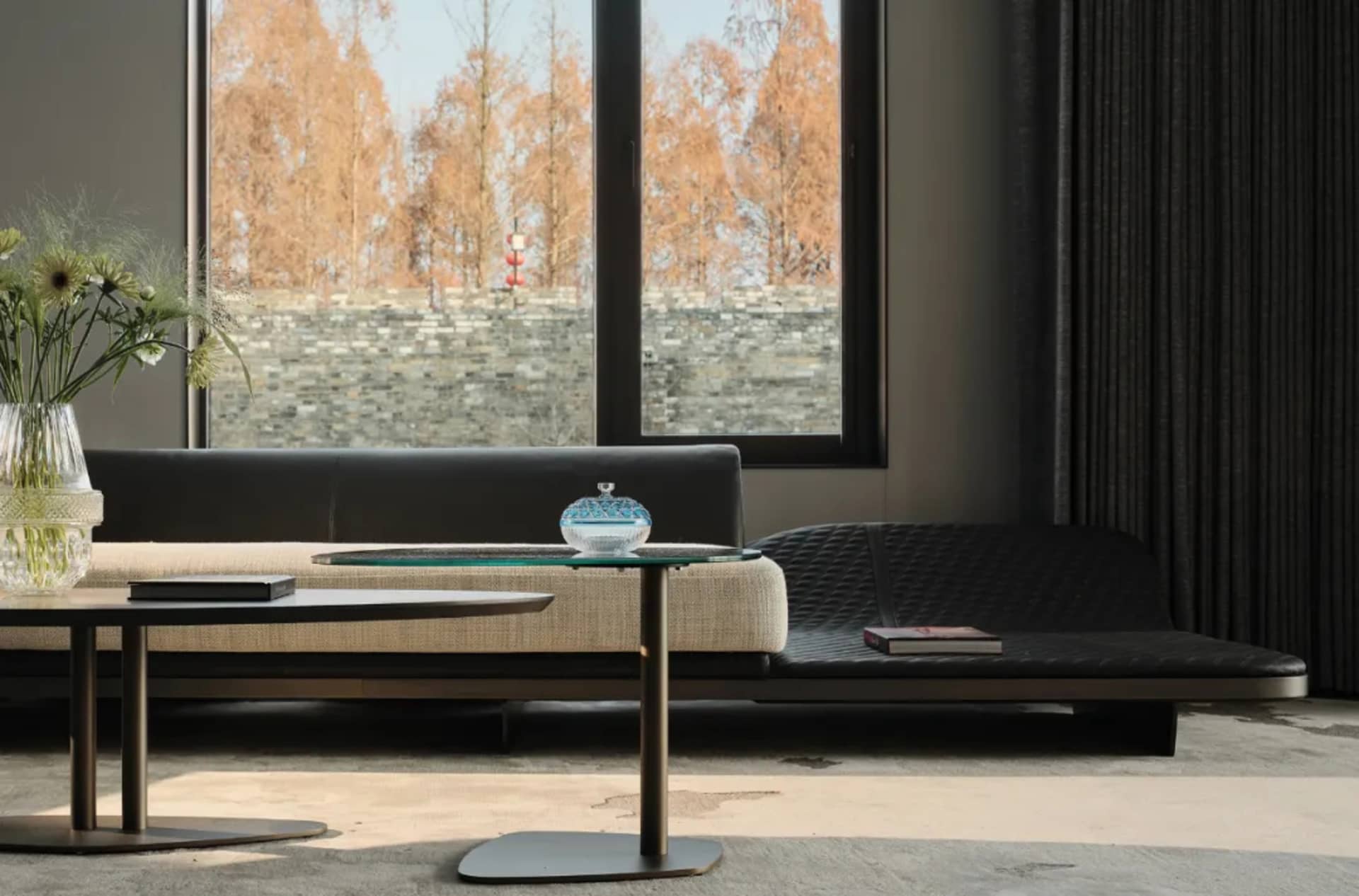 Modern living room with grey sectional sofa, minimalist coffee table, and natural fiber rug