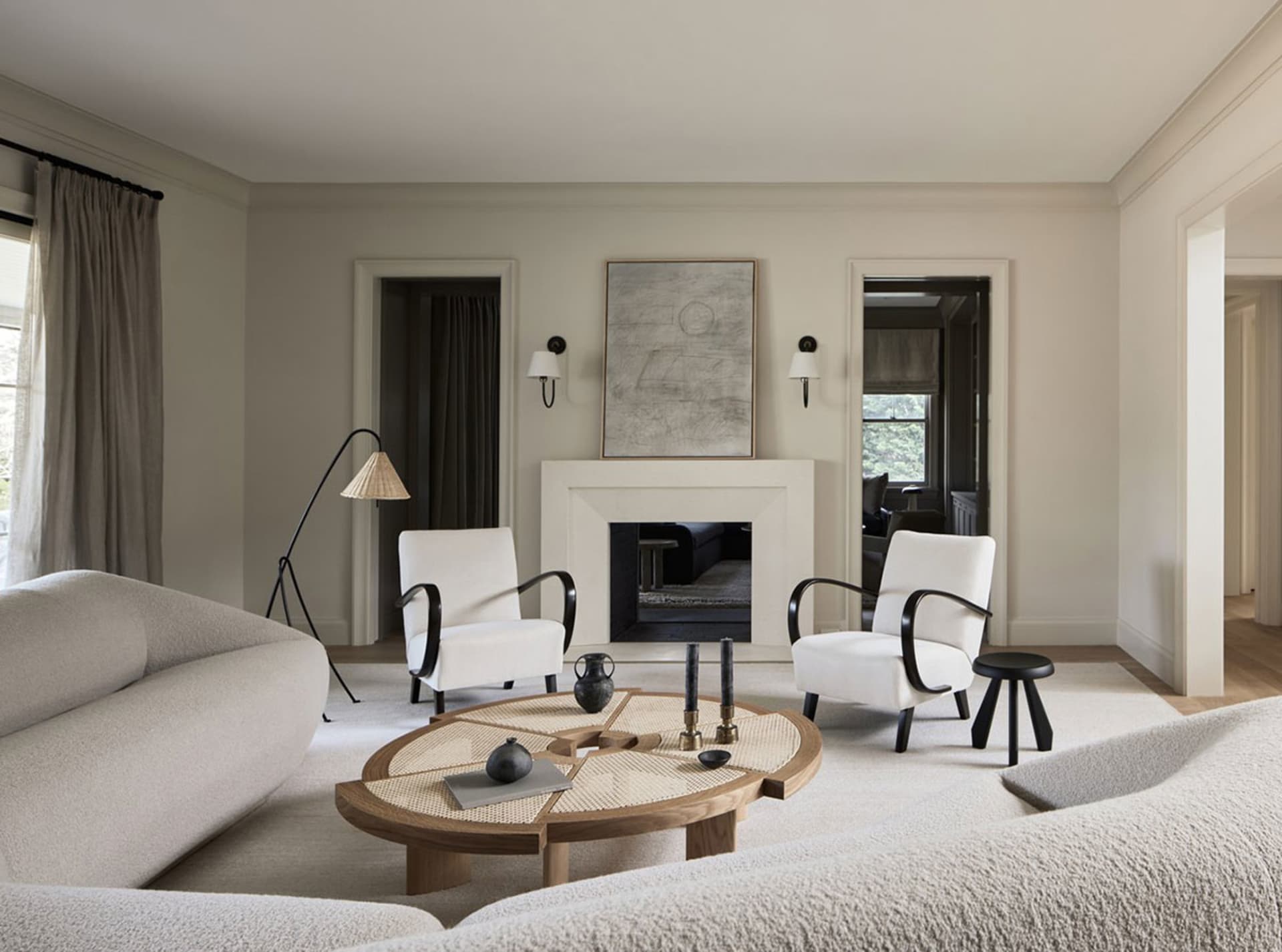 Modern living room featuring neutral-toned furniture and materials, minimalist design, and a cozy ambiance.