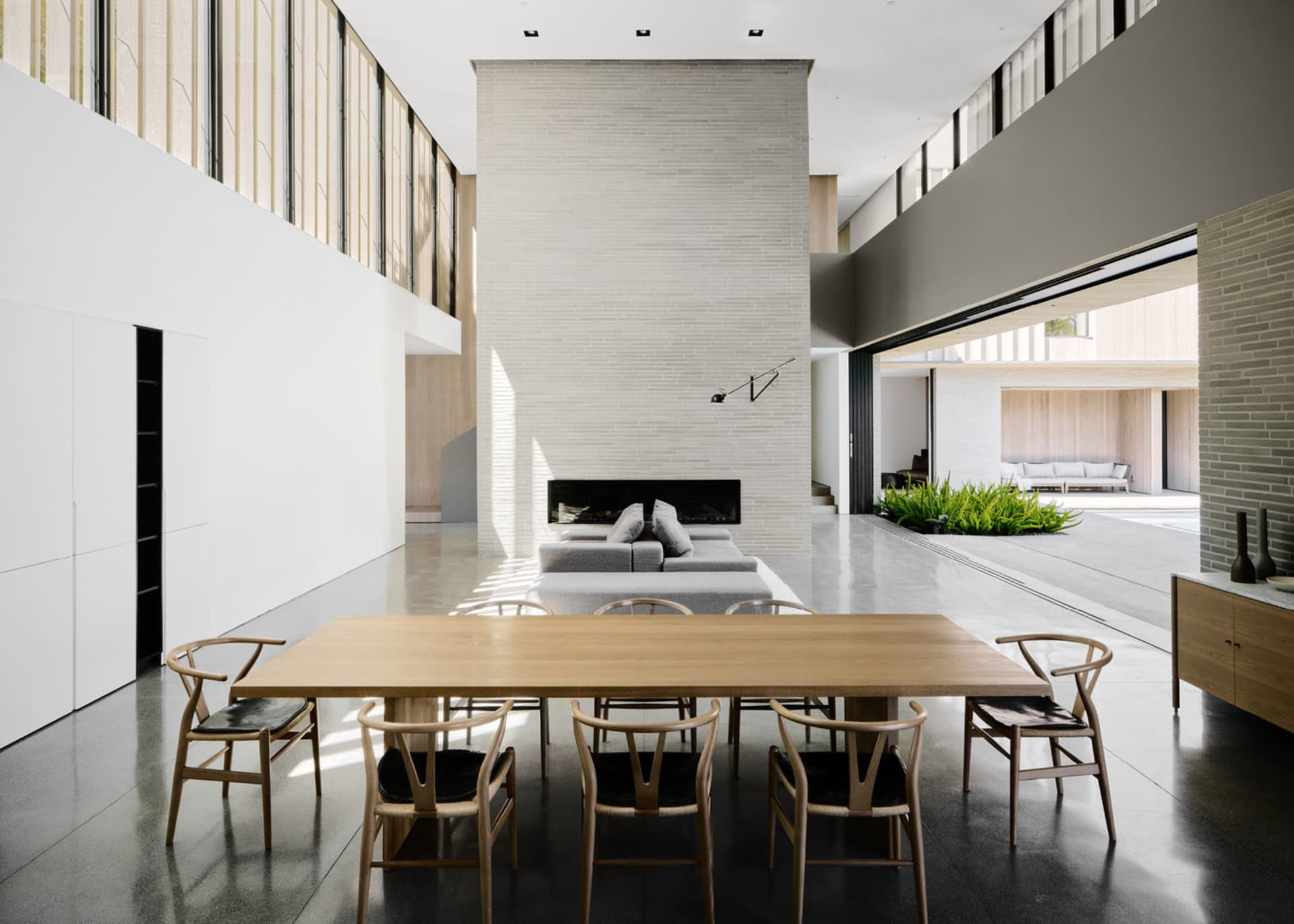 Modern residential interior featuring concrete, wooden, and brick elements.