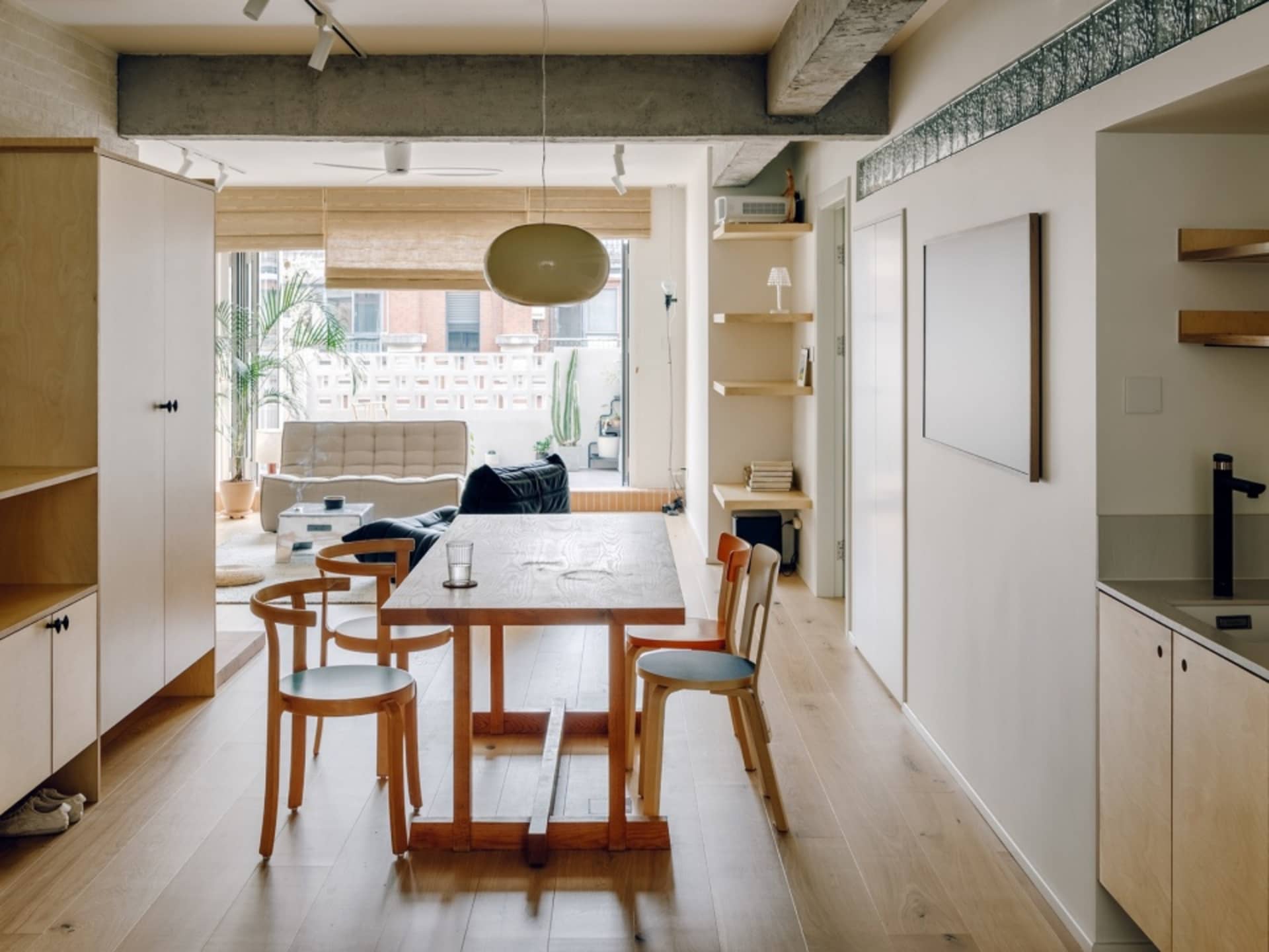 Modern residential interior featuring wooden furniture and concrete accents