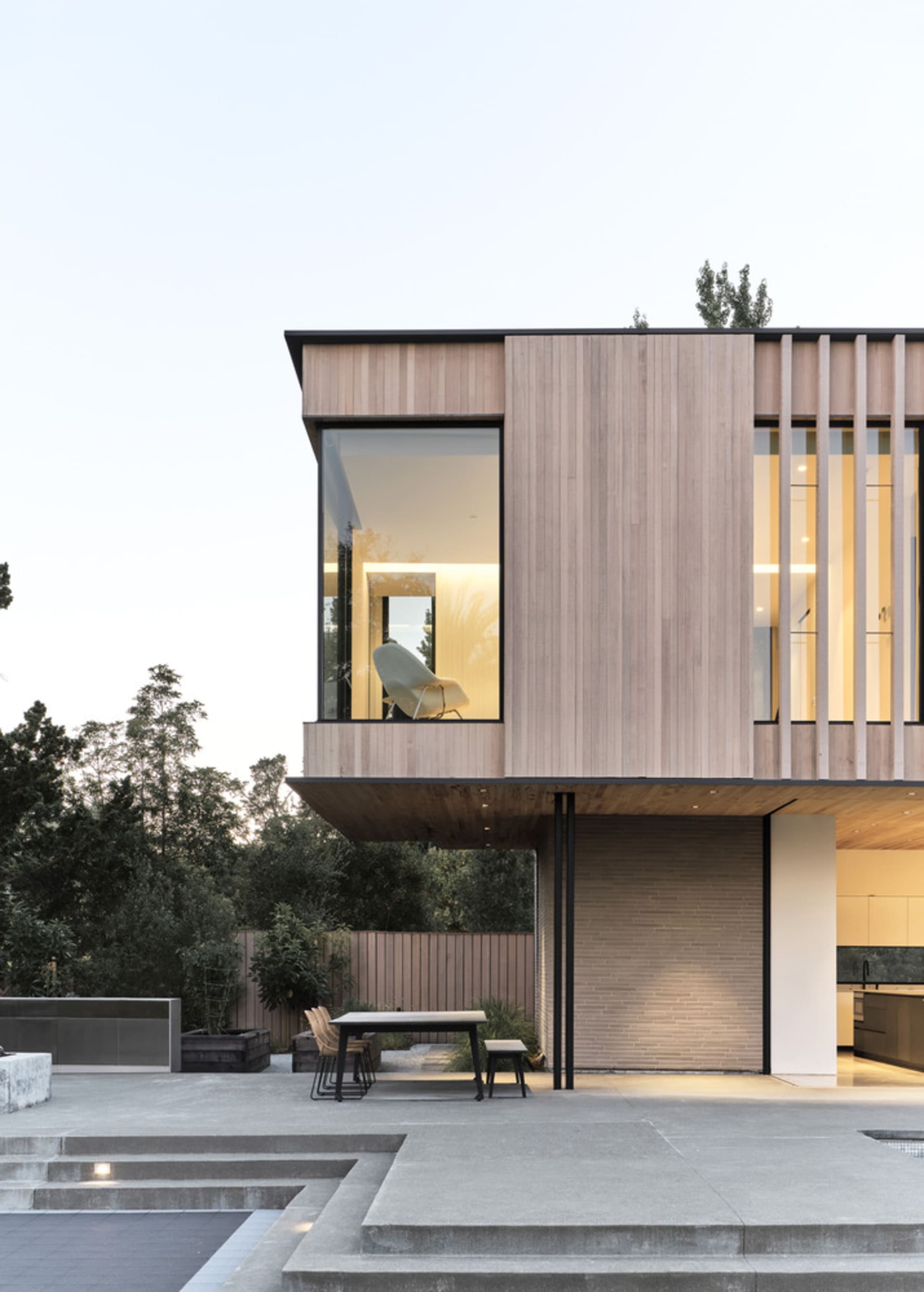 Modern house featuring a wooden exterior and large glass window