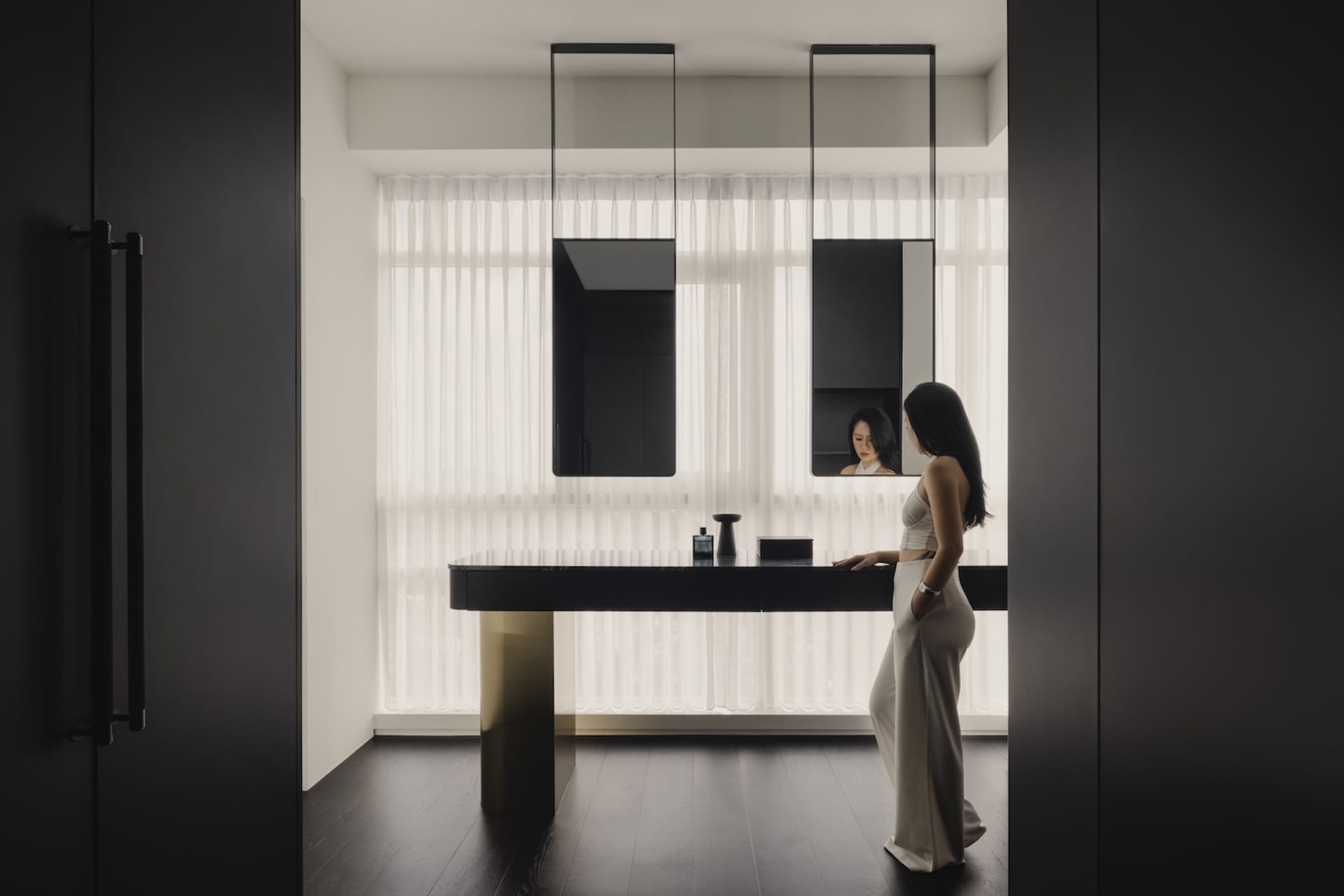 A modern bathroom with glass walls and wooden elements.