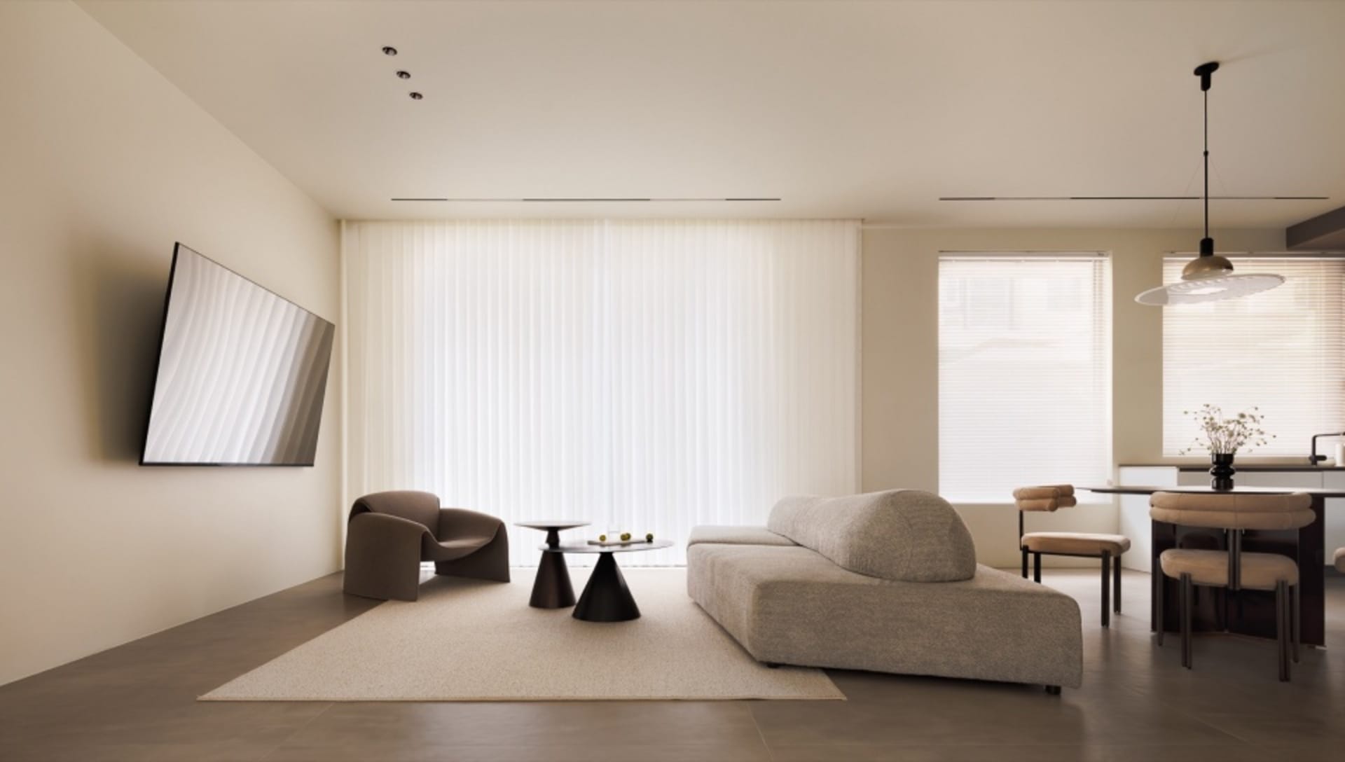 A modern minimalist living room with neutral materials and a large window.
