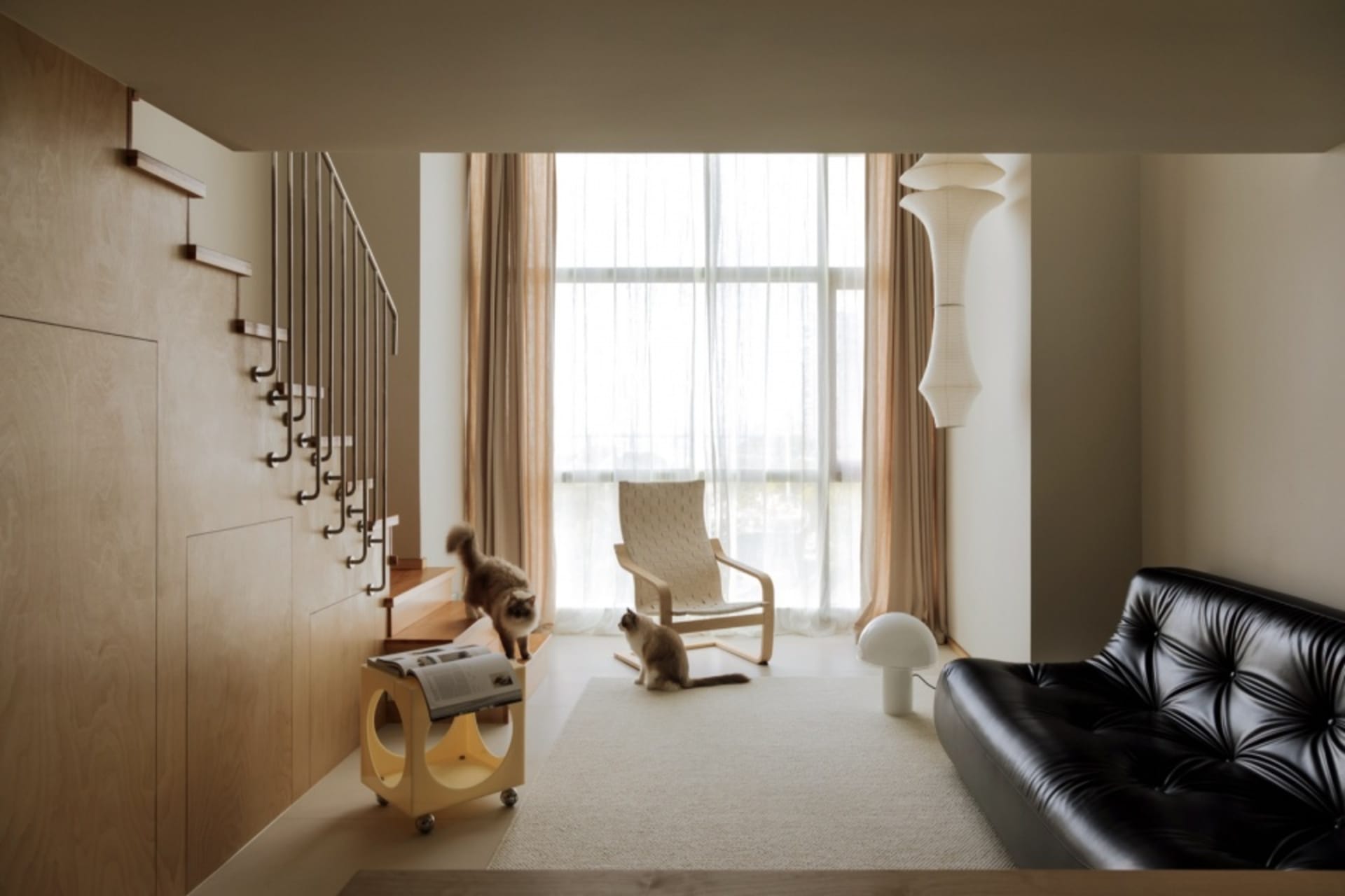 A modern living room featuring wood, glass, leather, and fabric.