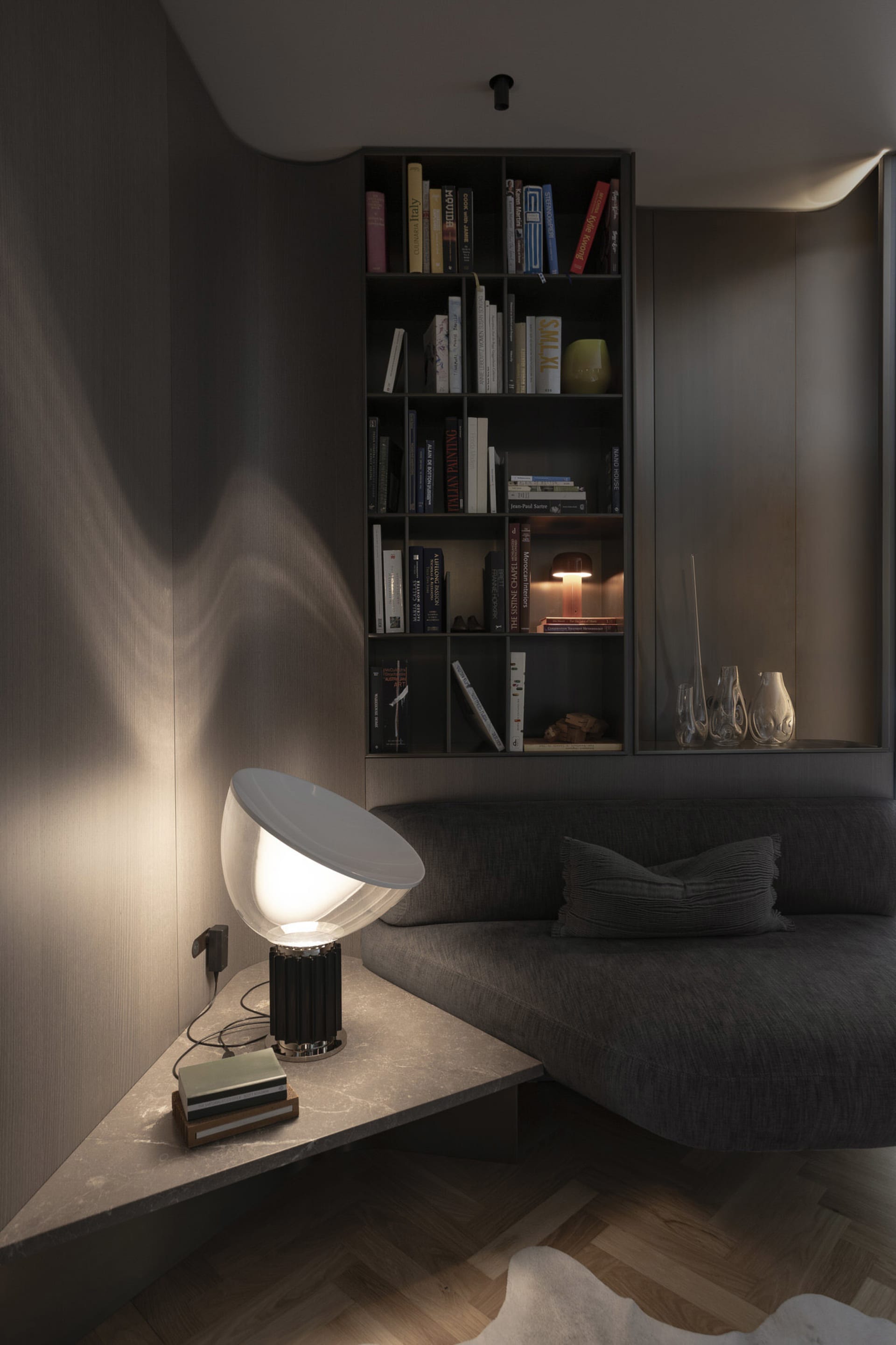 A modern living room featuring a sleek, minimalist concrete corner with a built-in bookshelf and contemporary lighting fixtur