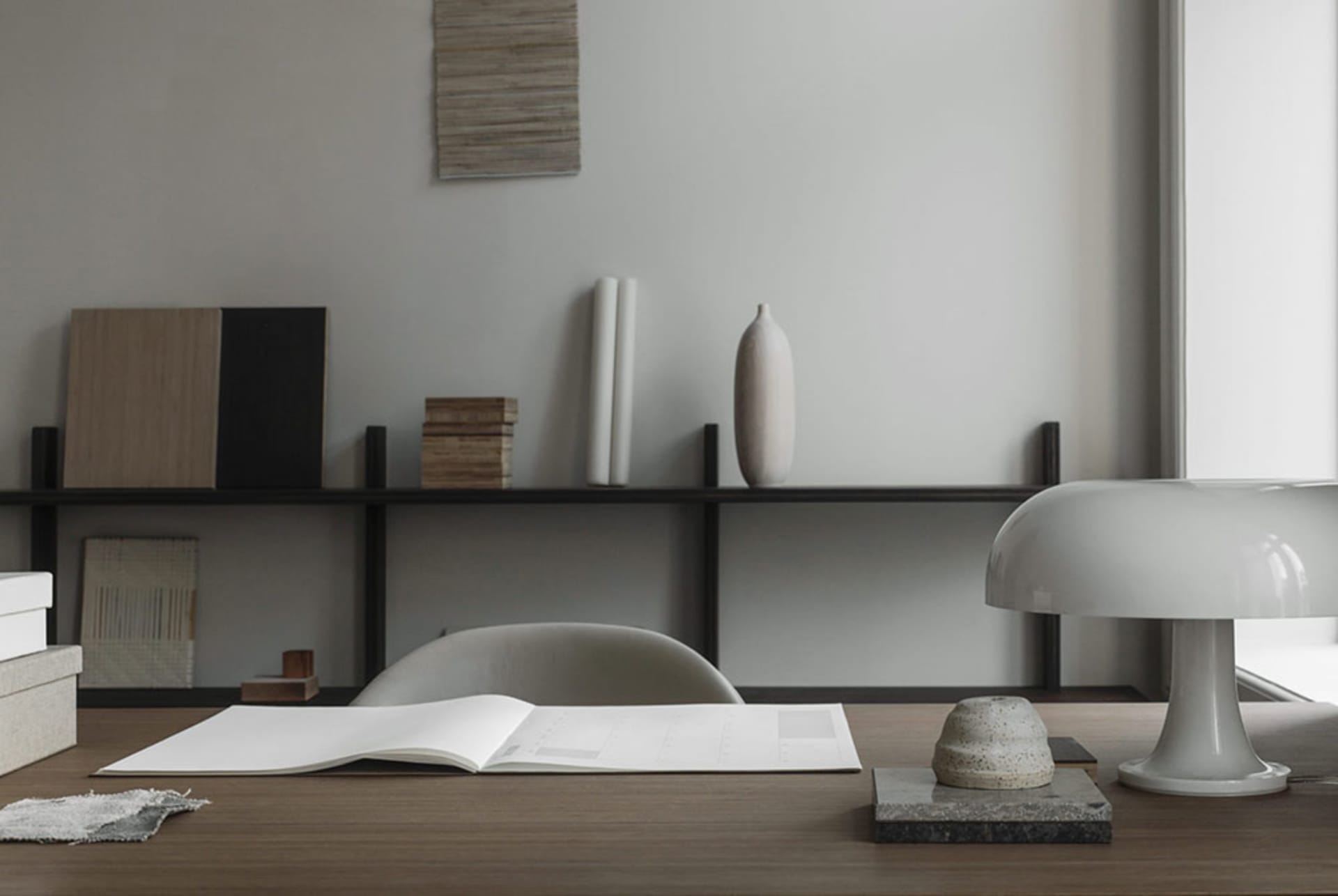 Modern workspace with minimalist furniture and wooden desk.