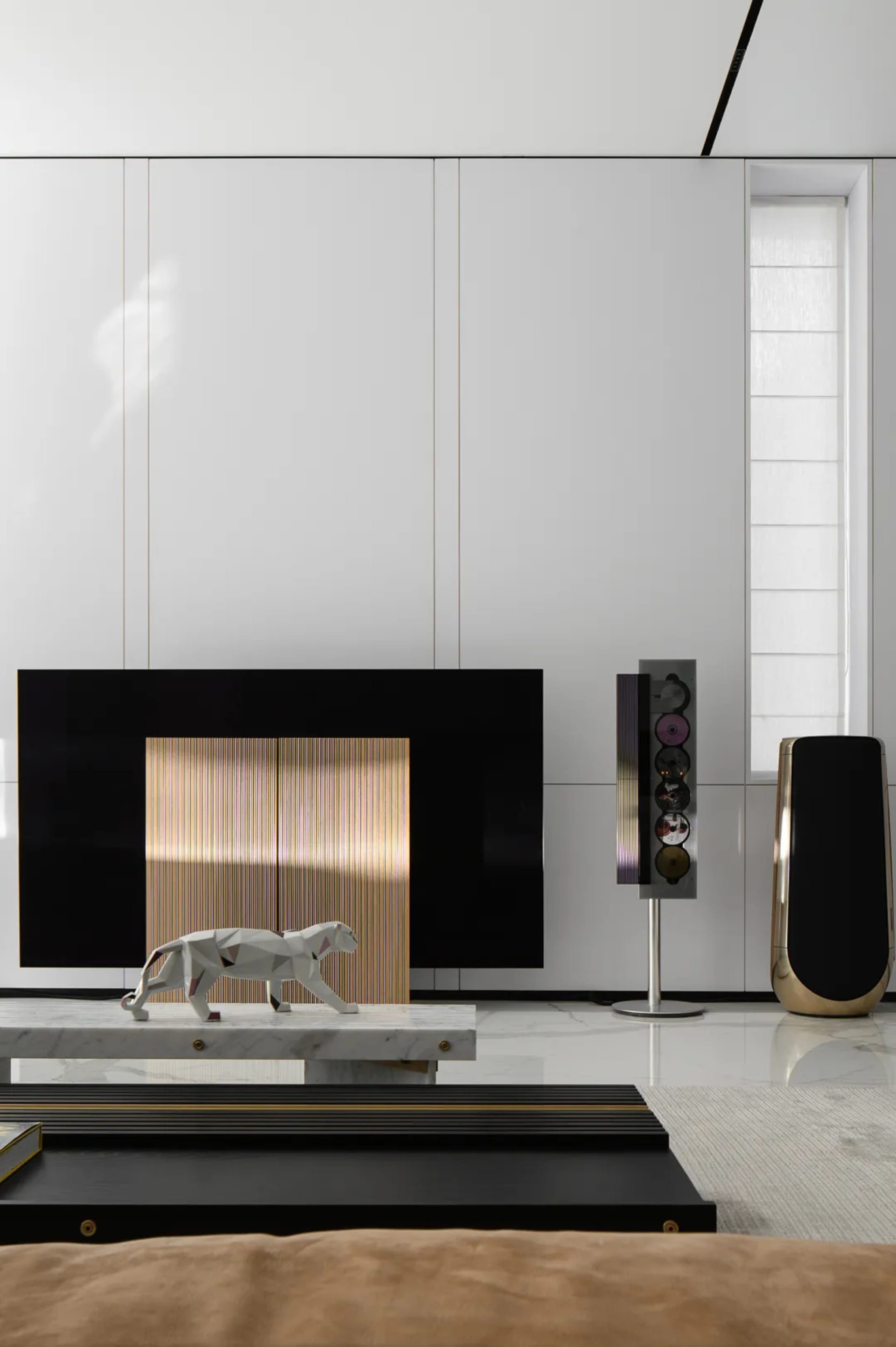 A minimalist living room featuring black metal furniture and a detailed sculpture of a jaguar.