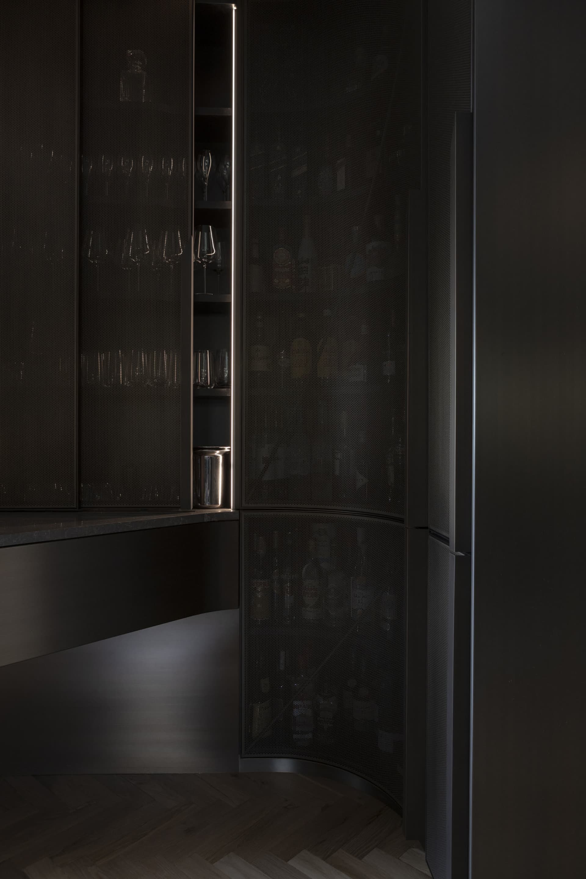 Modern interior design featuring a contemporary pantry cabinet with metal perforated panel.