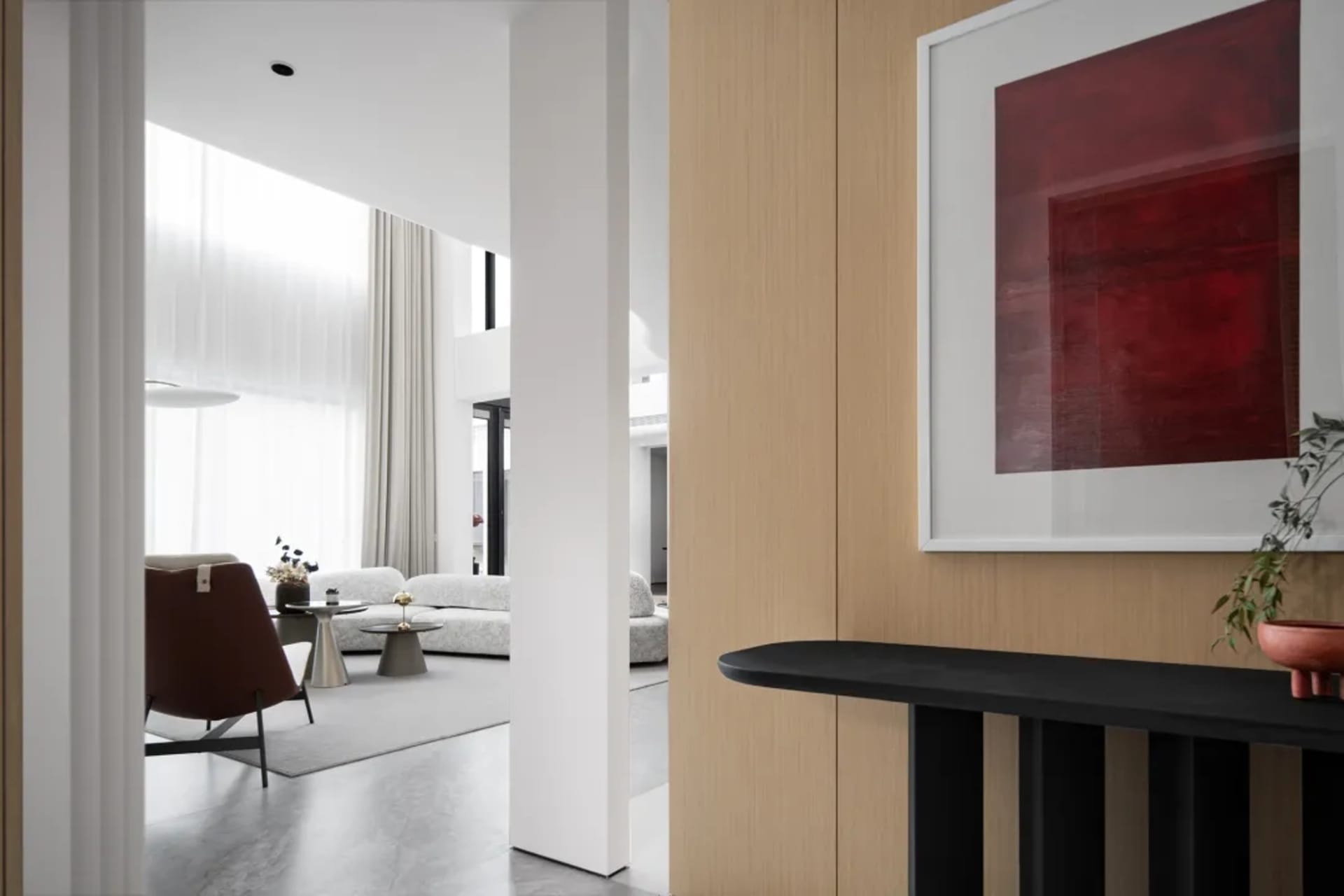 A modern living room featuring sleek, contemporary decor, clean lines, and a brown accent chair.
