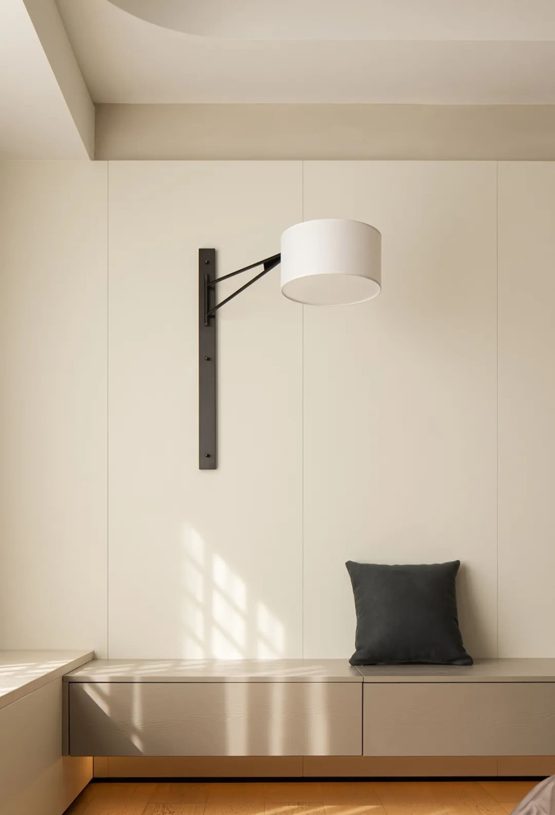 Modern minimalist bedroom with white furniture, wooden floor, and light fixture