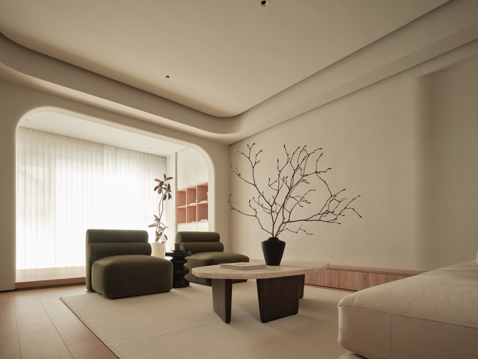 A minimalist living room featuring modern wooden furniture and a round coffee table with a plant.