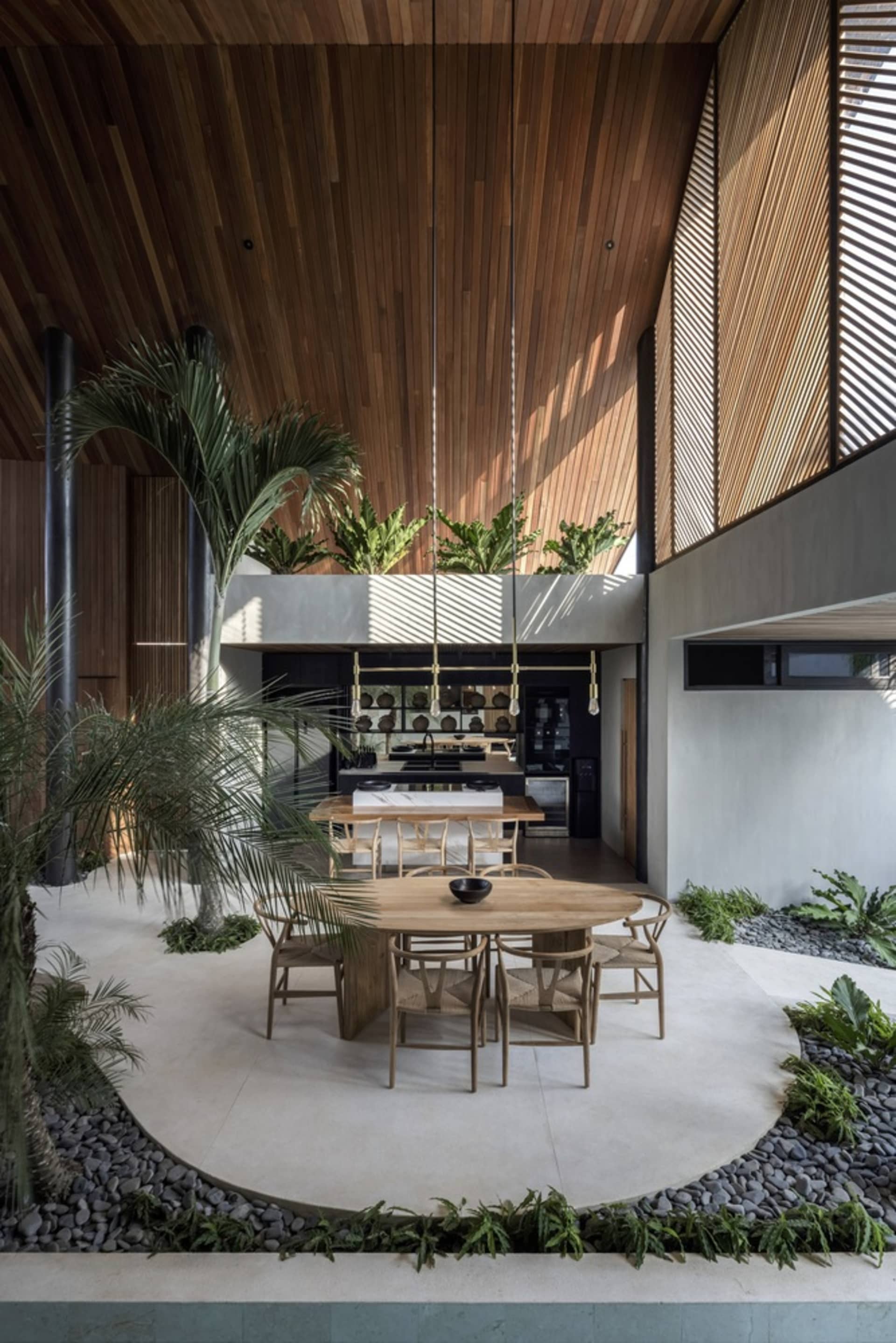 Modern residential interior featuring a combination of wood, concrete, and stone materials.