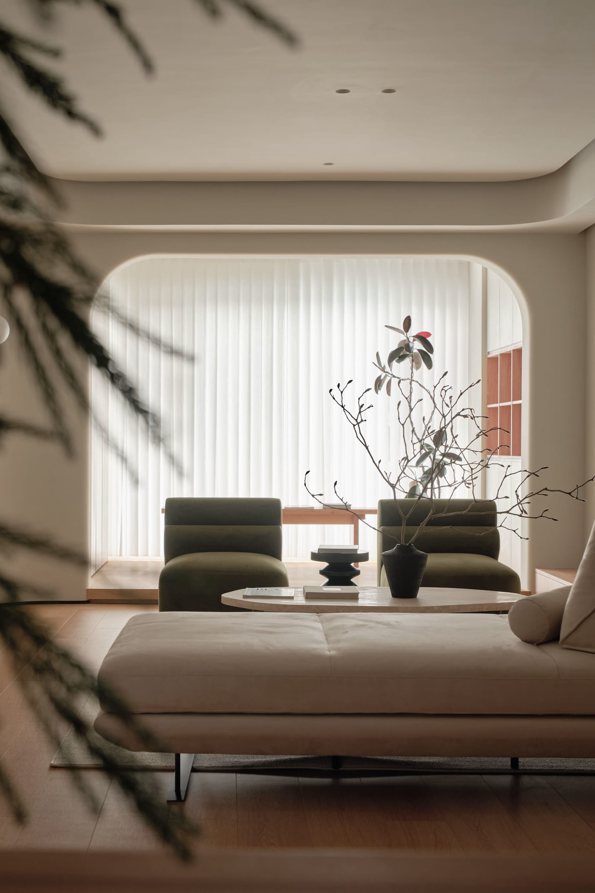 A modern minimalist living room with neutral colors and contemporary furniture.