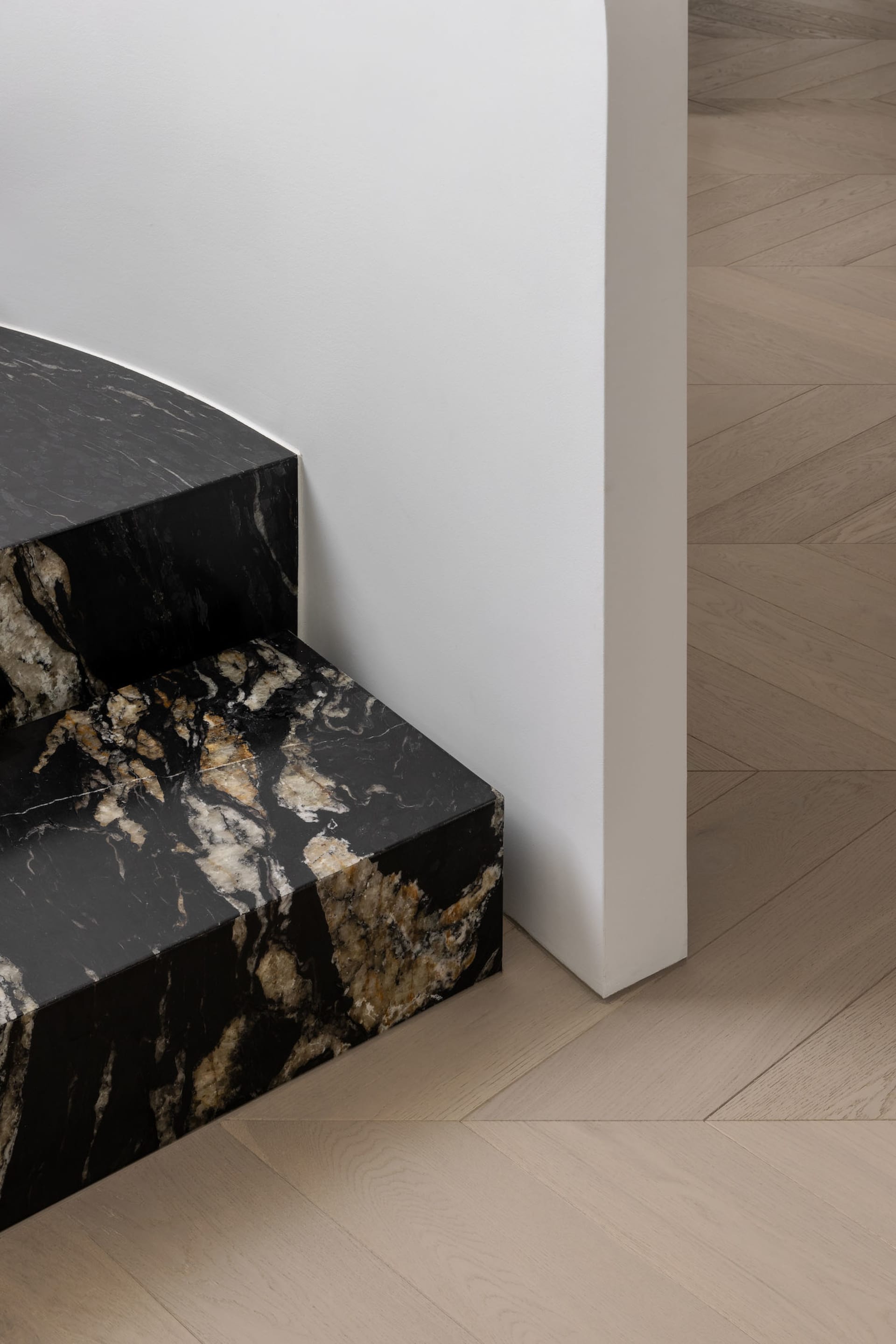 Modern interior space with marble flooring and steps.