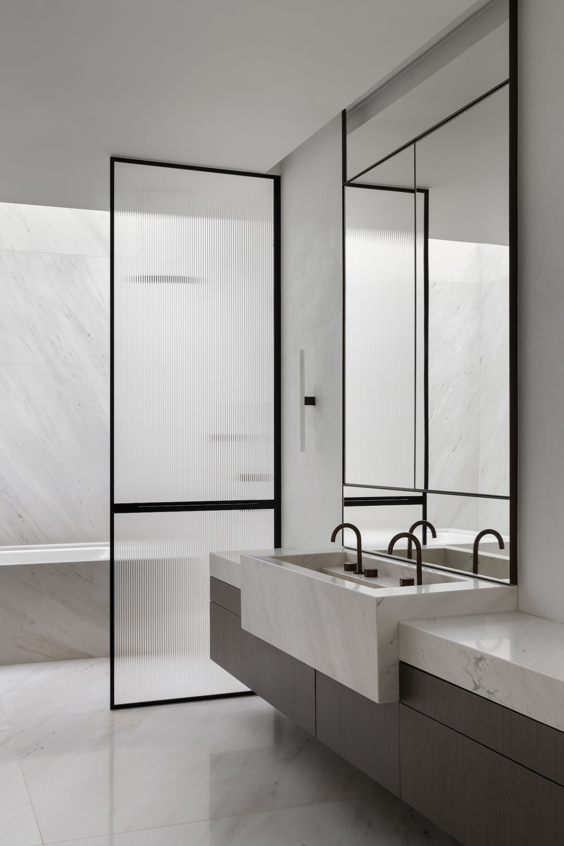 A modern bathroom with minimalist design featuring white marble