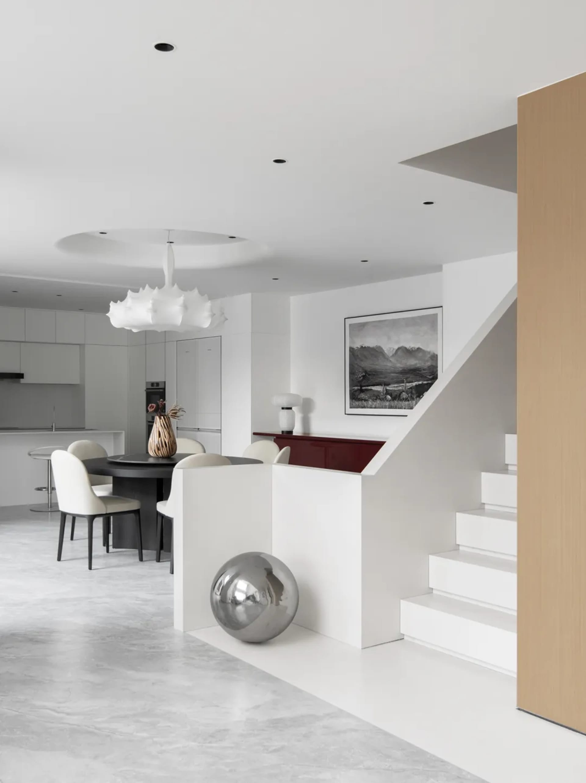 A minimalist residential interior with white marble and white lacquer finishes