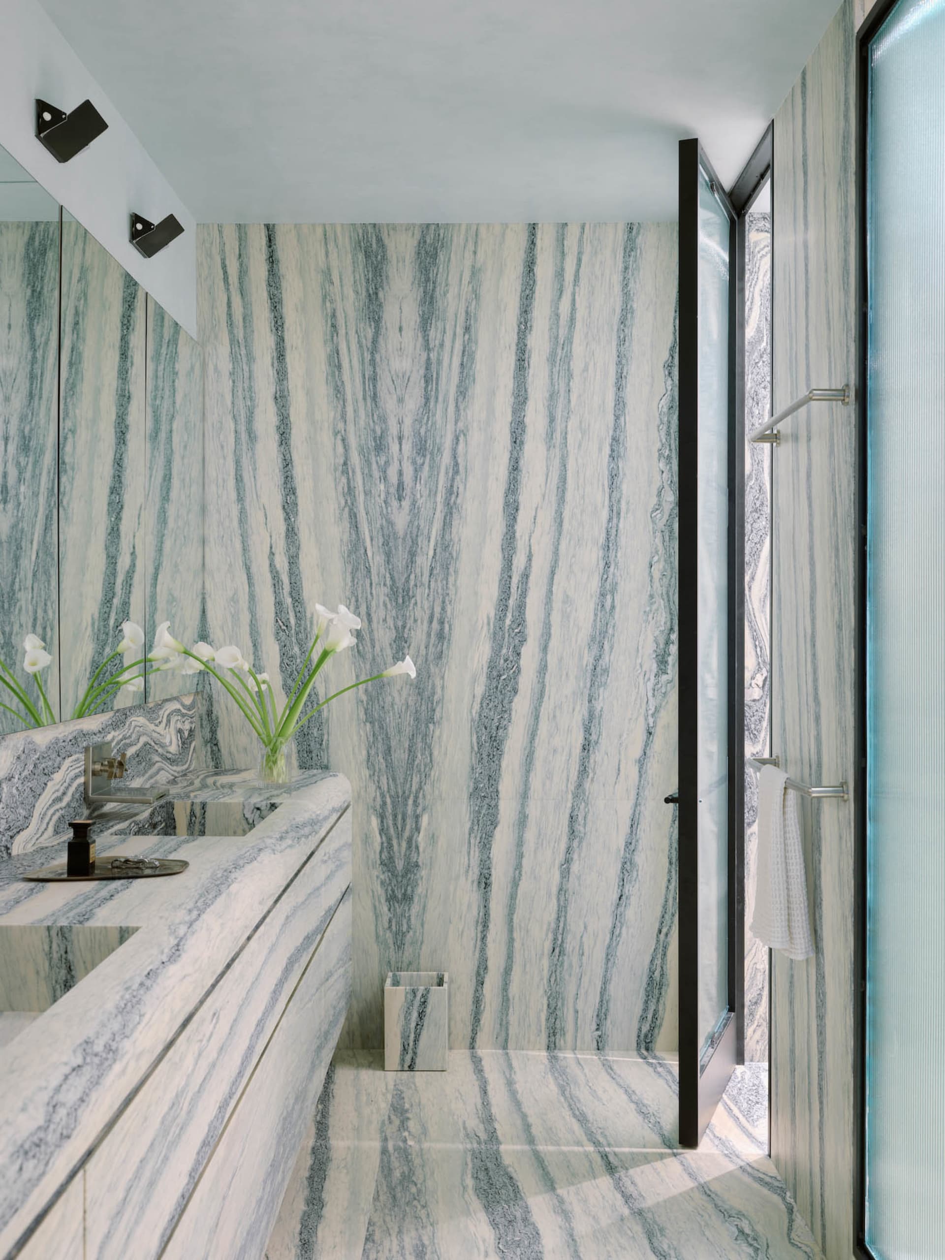 Modern bathroom with marble walls and floor, clean and clutter-free design.