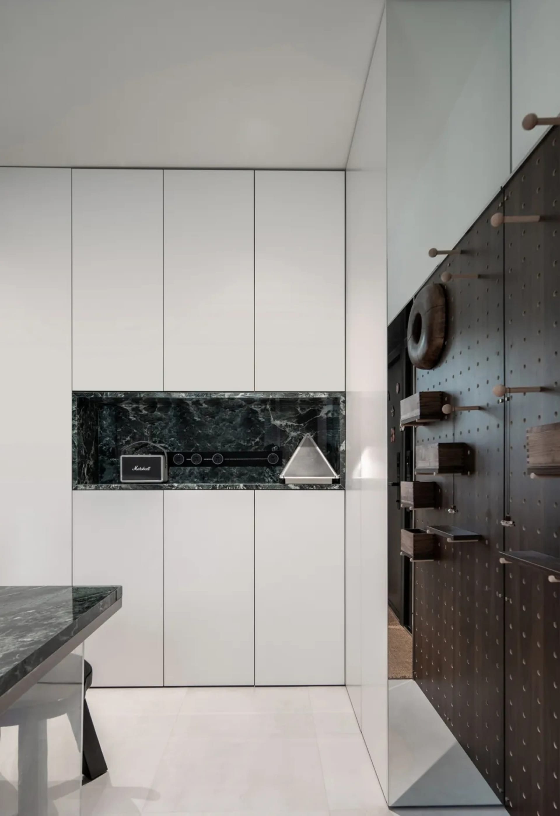 An industrial-style storage unit featuring metal finishes and a marble countertop.