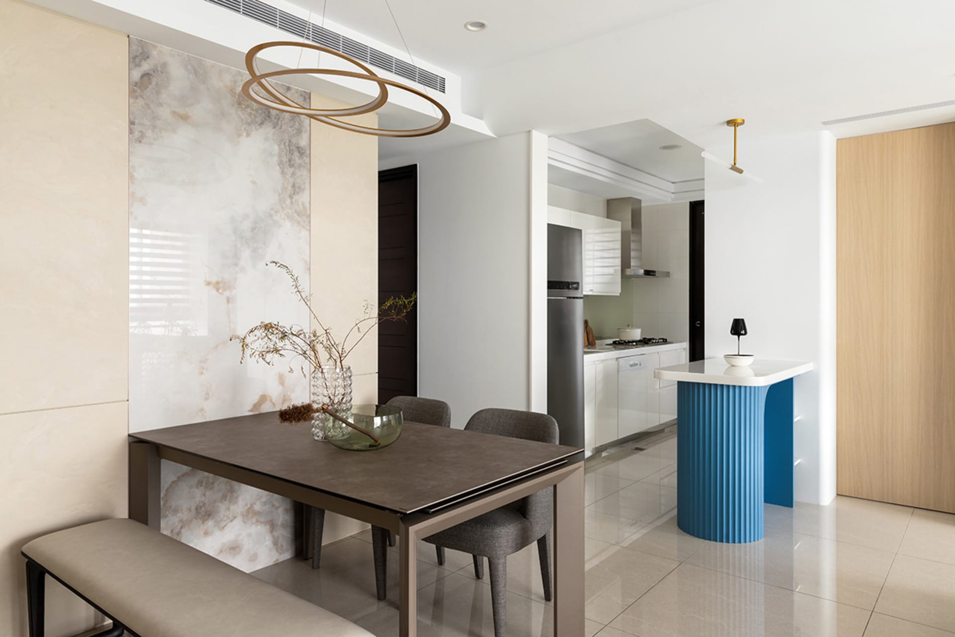 Modern dining and living room featuring a marble table and contemporary design elements