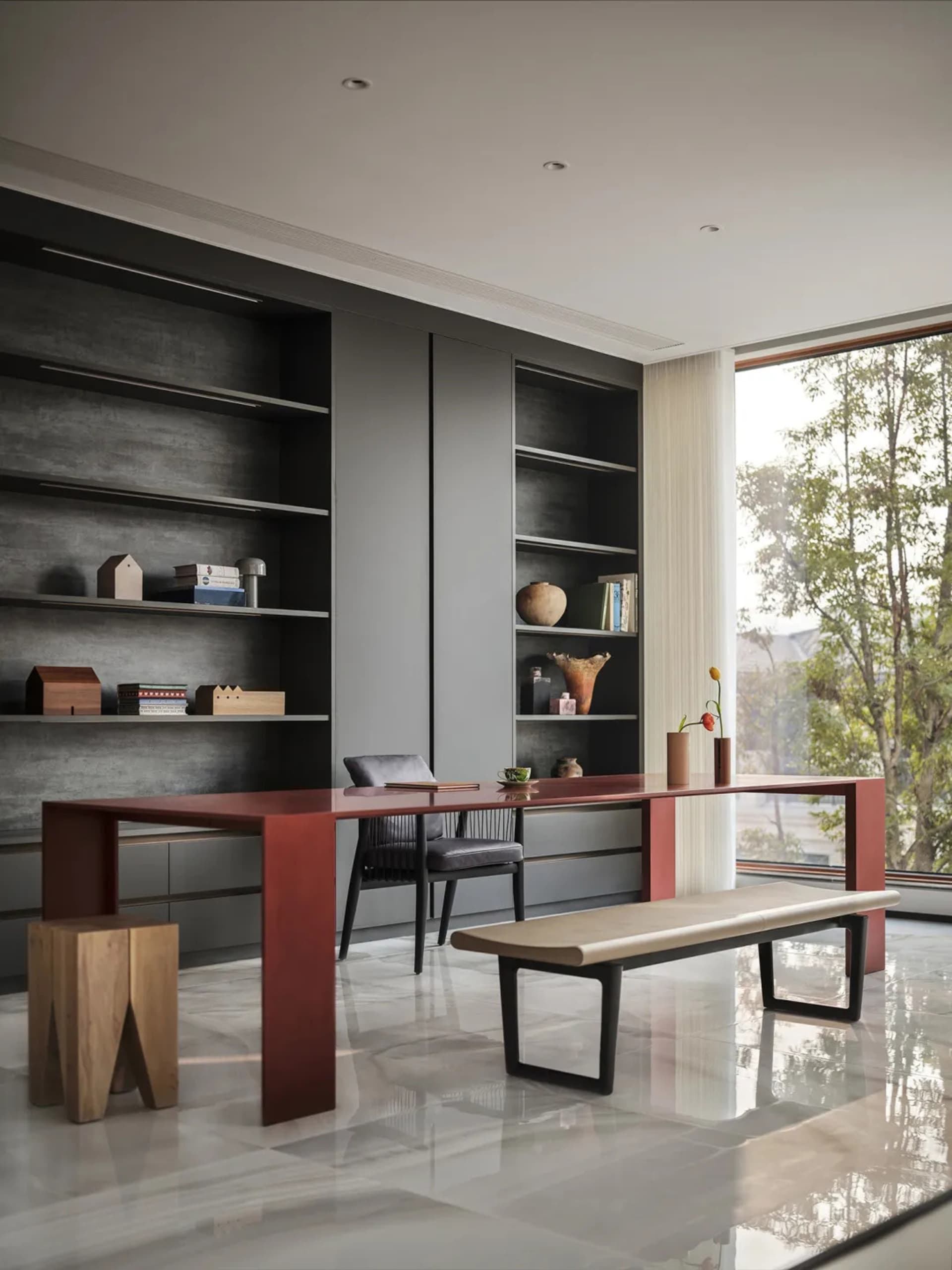 Photograph of a modern office space featuring a sleek, wooden desk, glass shelves, and a minimalist aesthetic with a view of