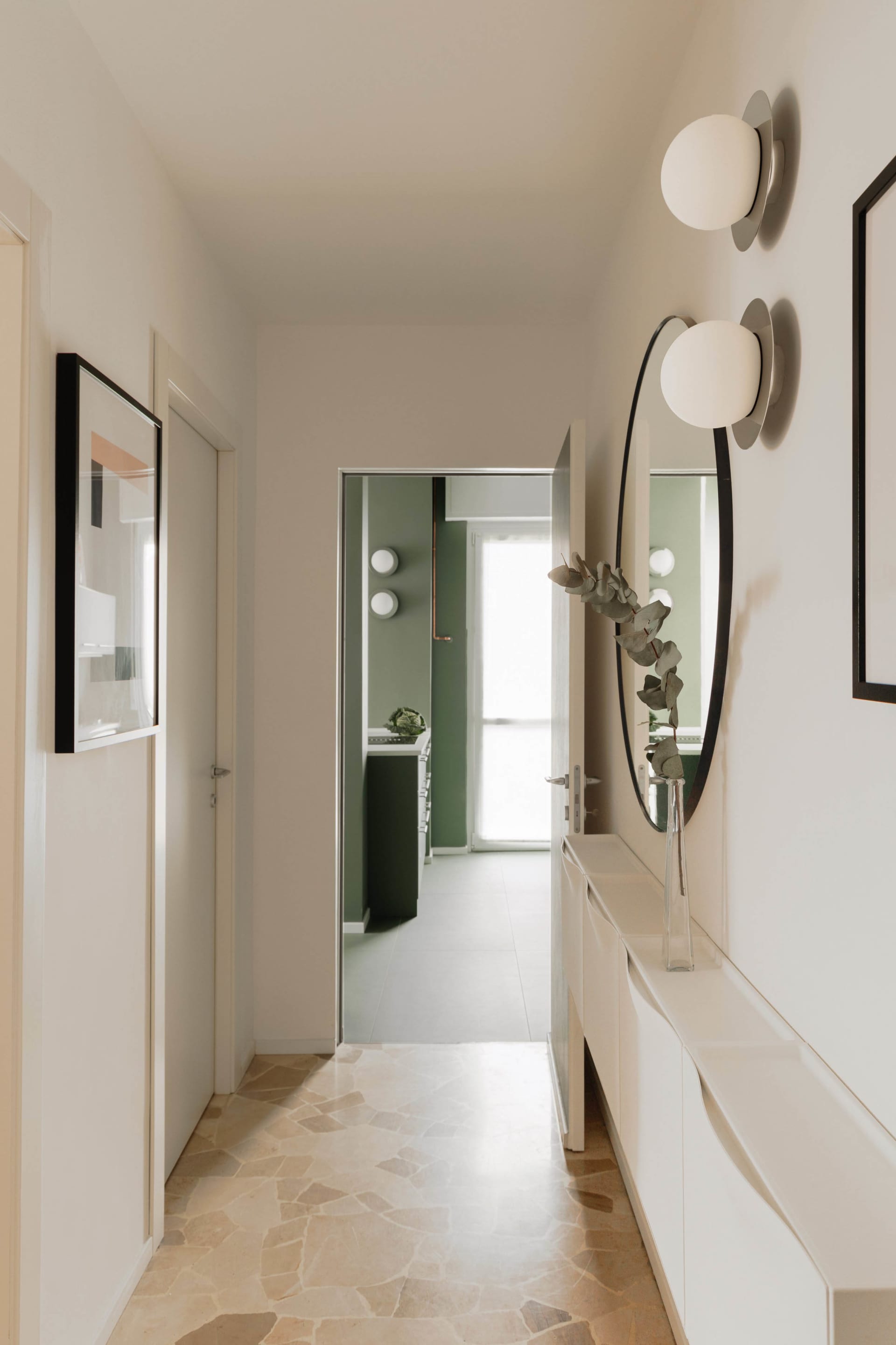 A modern interior corridor with neutral flooring and minimalist decor.