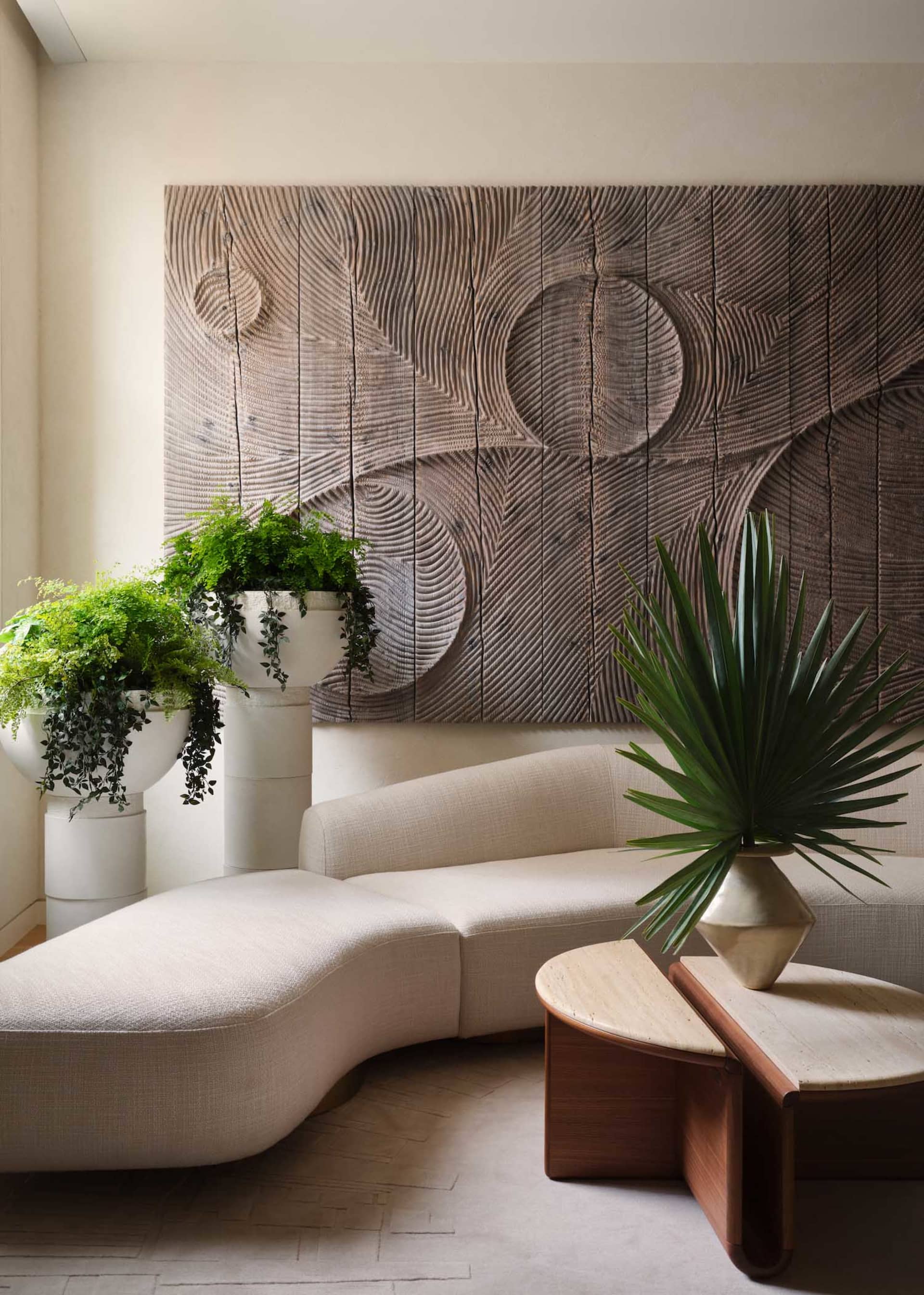 Modern living room featuring wood, concrete, and green plants