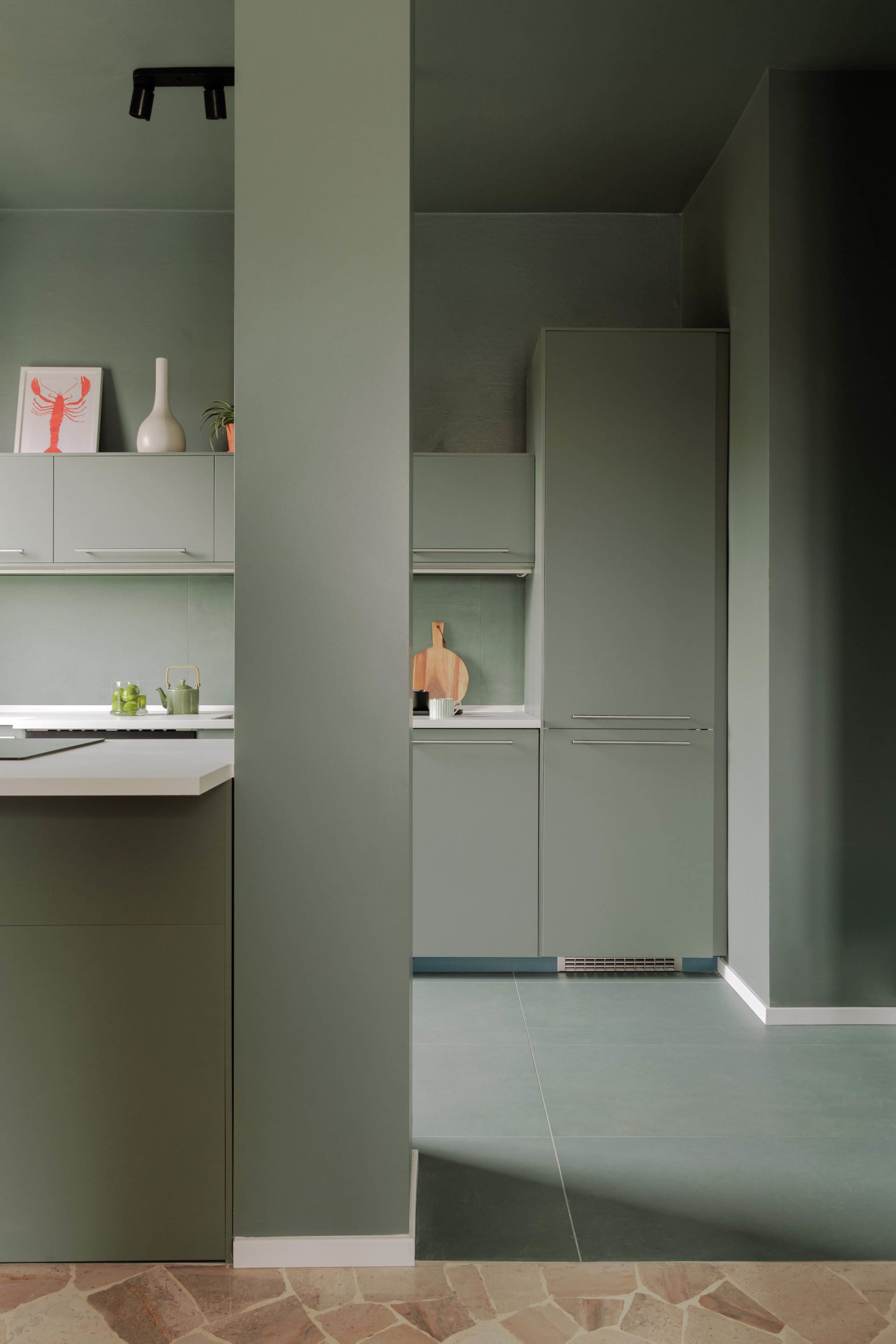 A modern kitchen featuring a terrazzo floor and minimalist design elements.