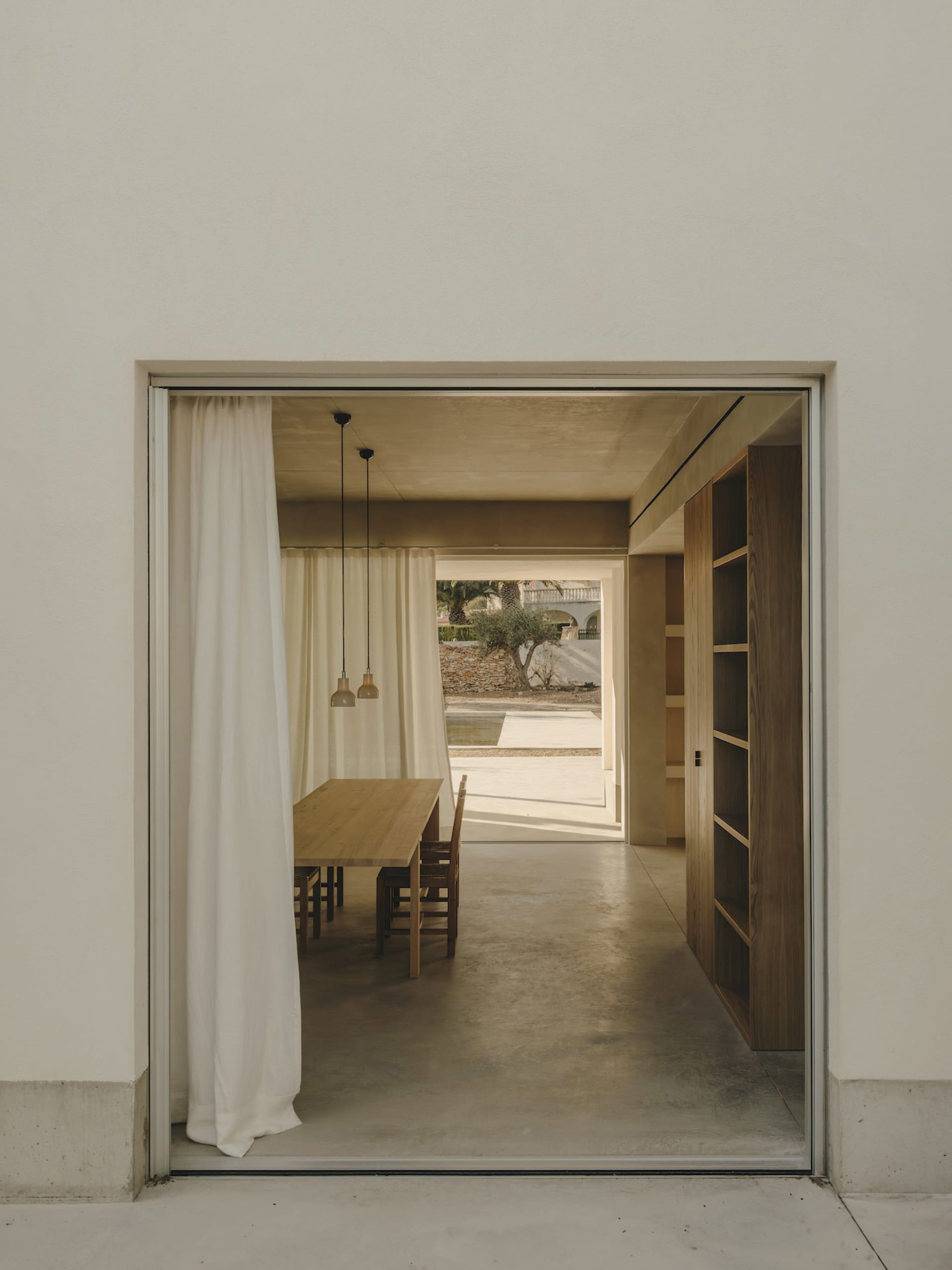 A minimalistic interior design featuring concrete and wooden elements.