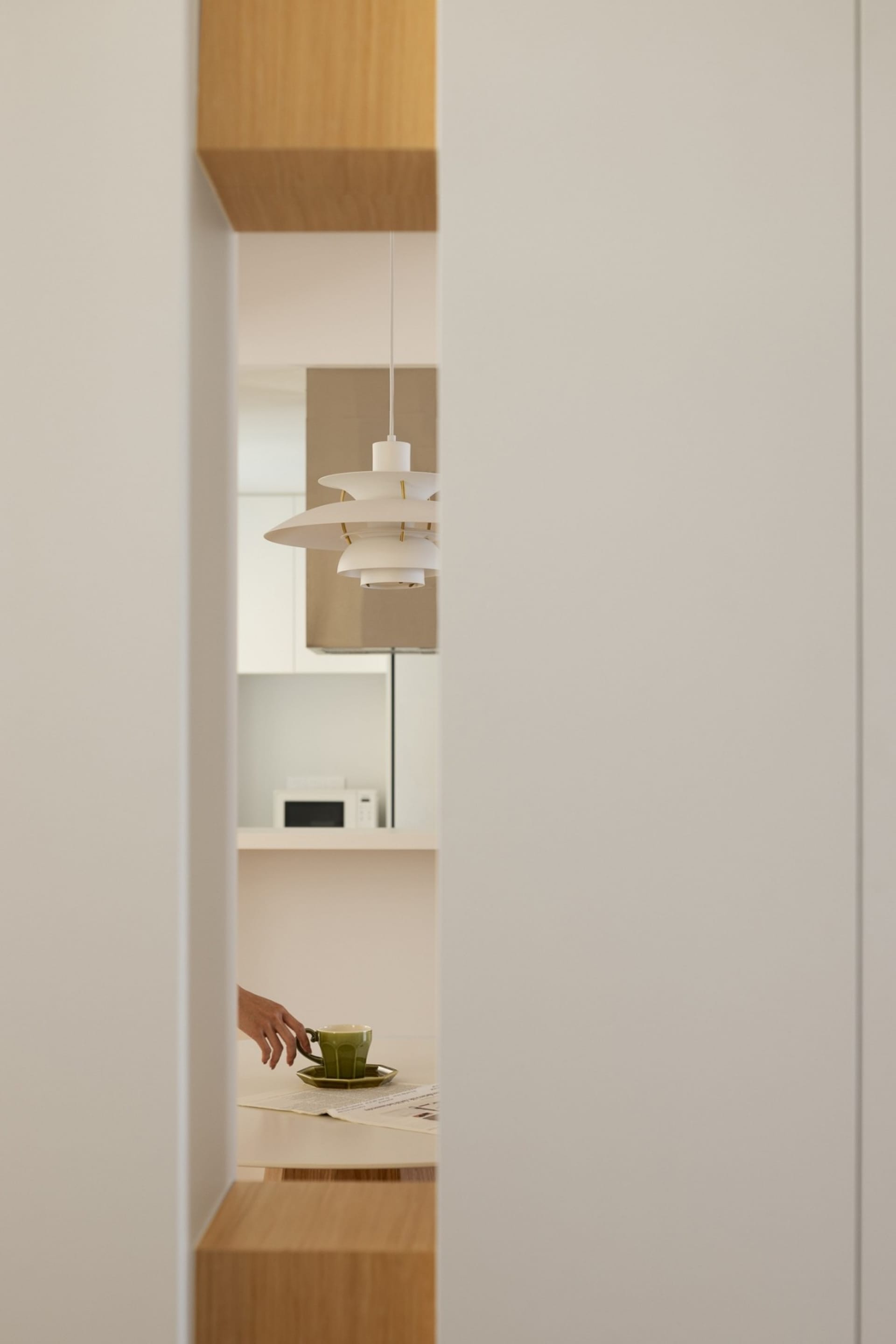 A minimalist kitchen with white cabinets and a countertop.