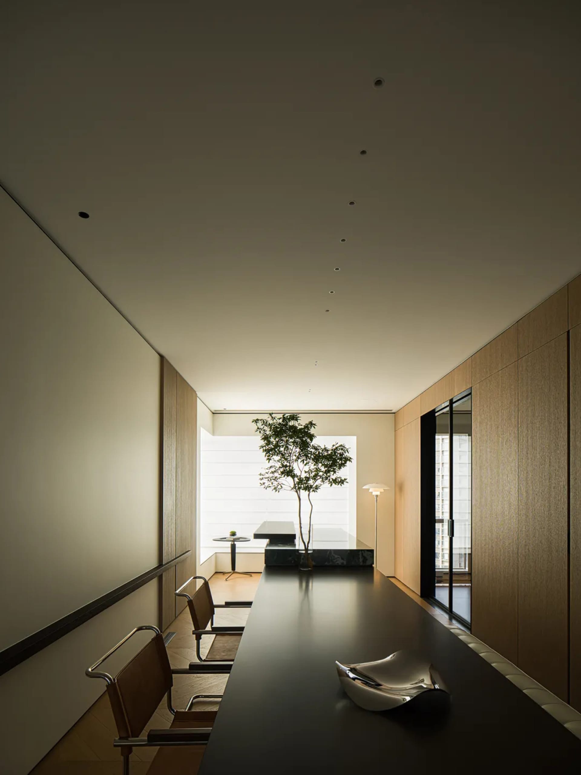 Minimalist living room with a sleek, modern design featuring bamboo elements and ample natural light.