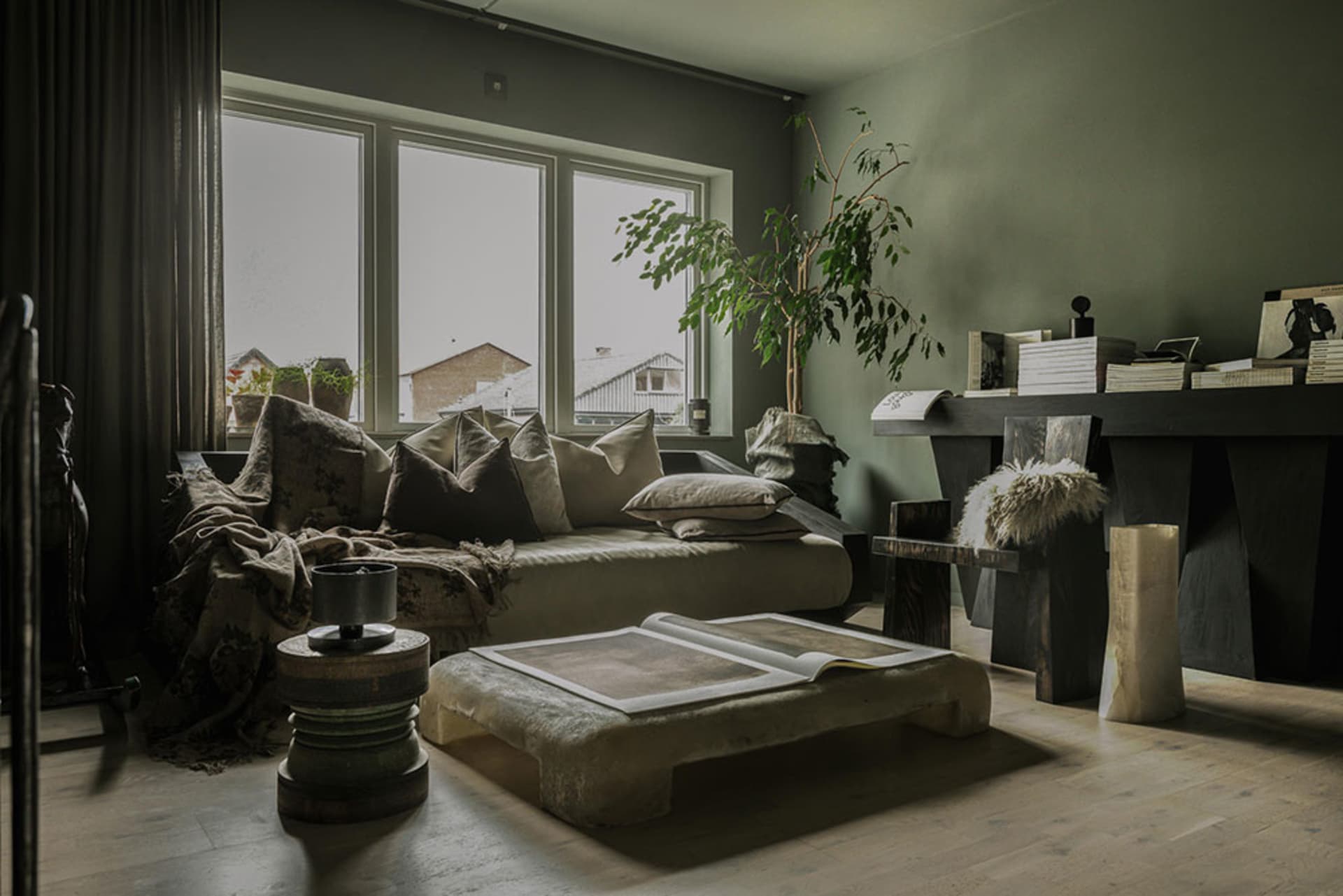 A modern living room featuring concrete furniture and wooden accents