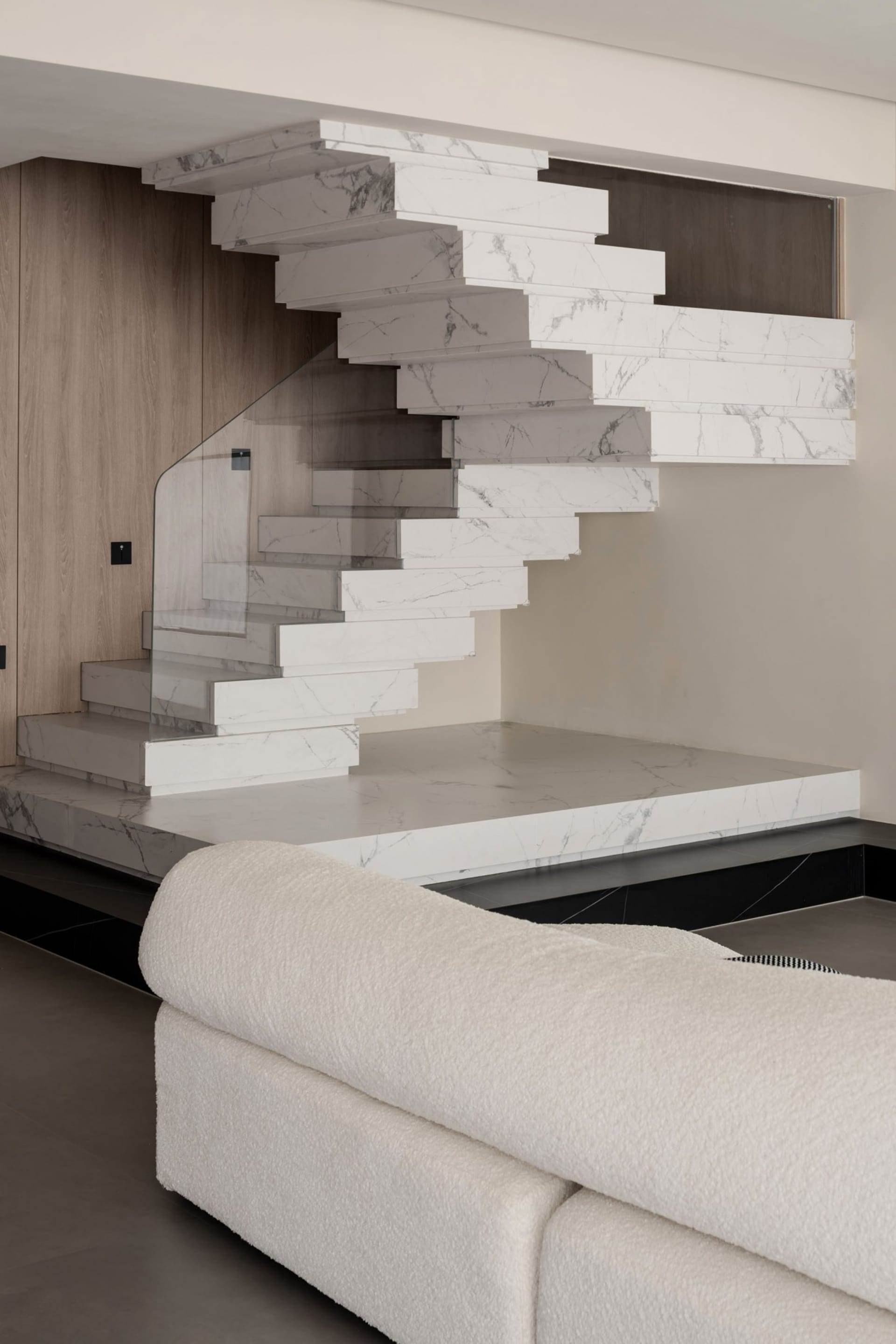 Modern interior design featuring a contemporary marble staircase in a living room setting.