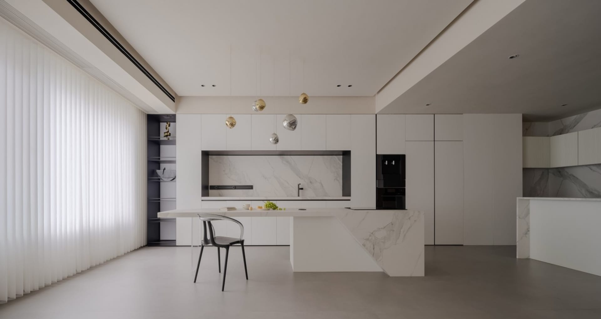 A modern residential kitchen featuring marble finishes and minimalist design.