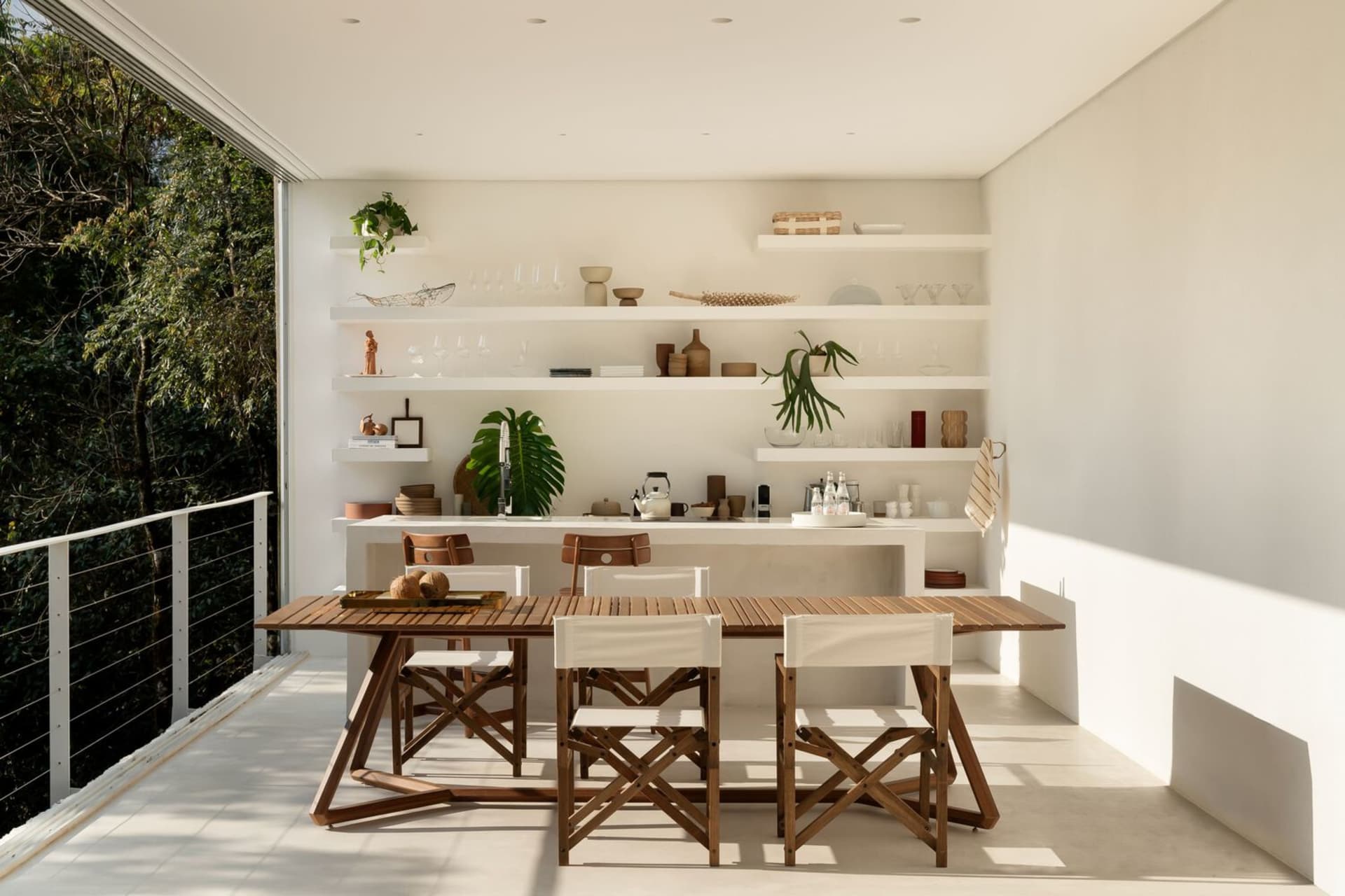 A modern dining room with wooden furniture and white decor elements.