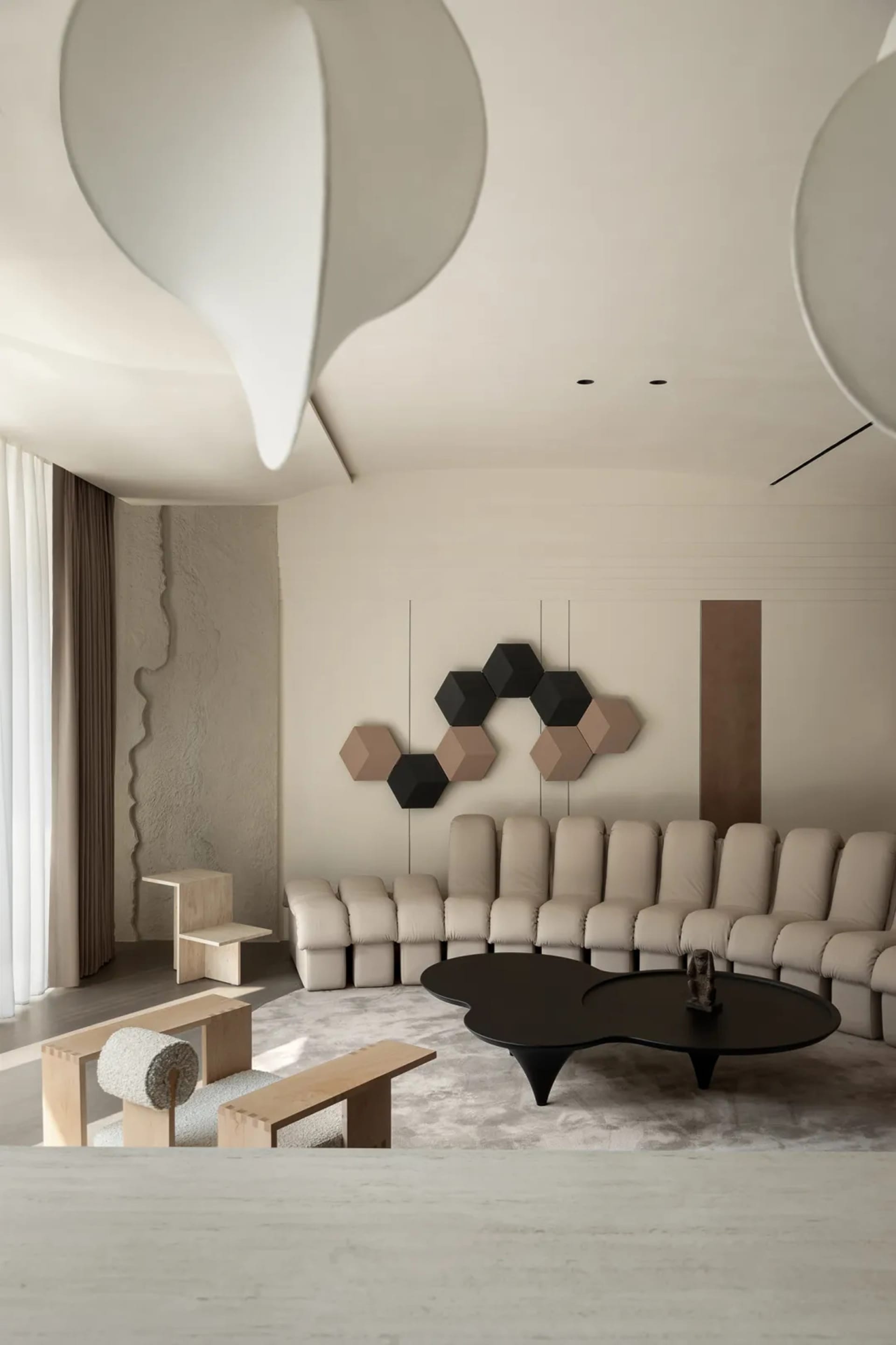 Contemporary living room featuring a neutral-toned color palette with modern furniture, clean lines, and geometric patterns.
