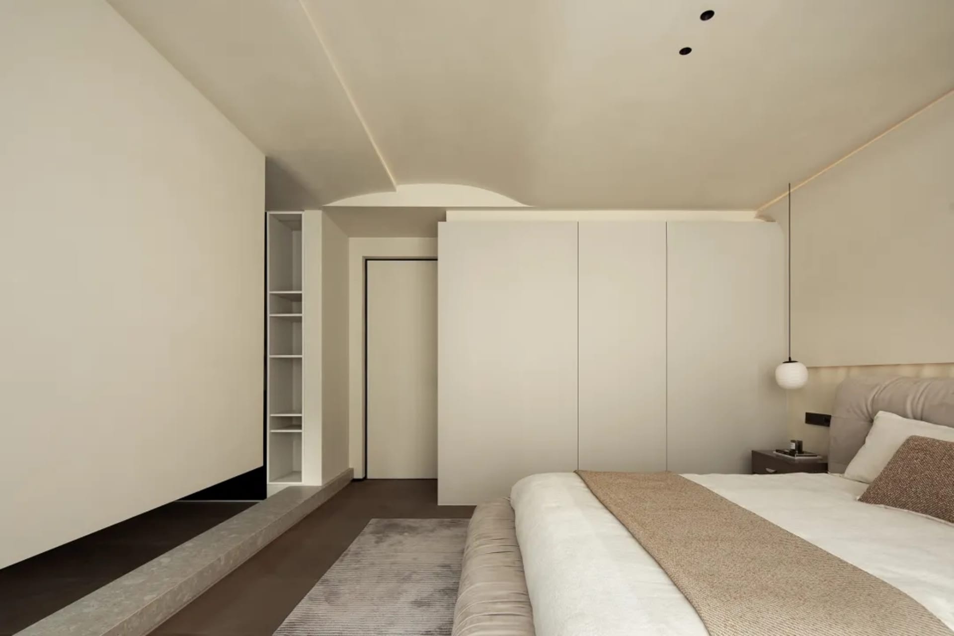 A modern bedroom featuring white walls and a large bed.