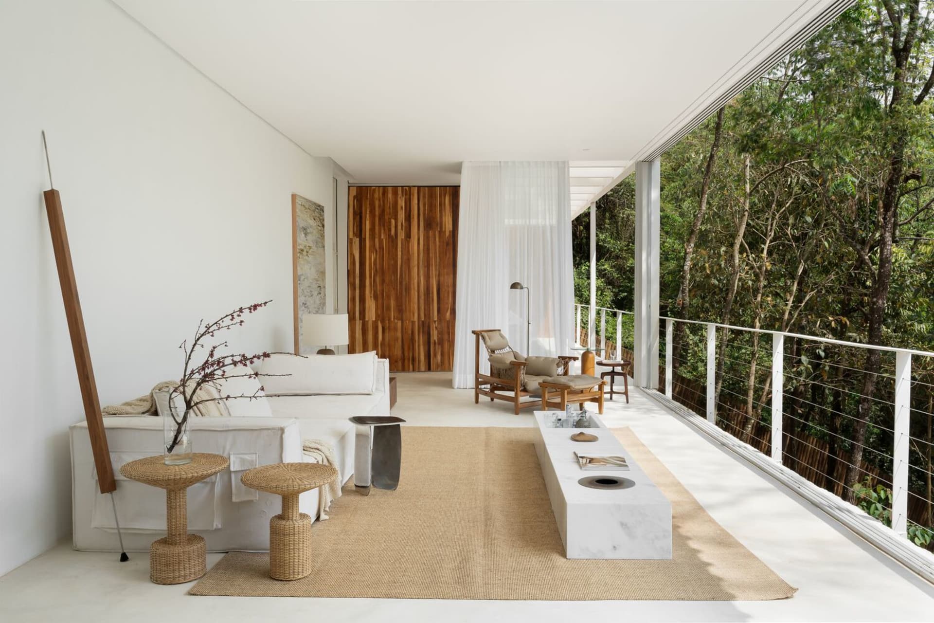 Modern living room featuring a white interior with wooden elements and furniture.
