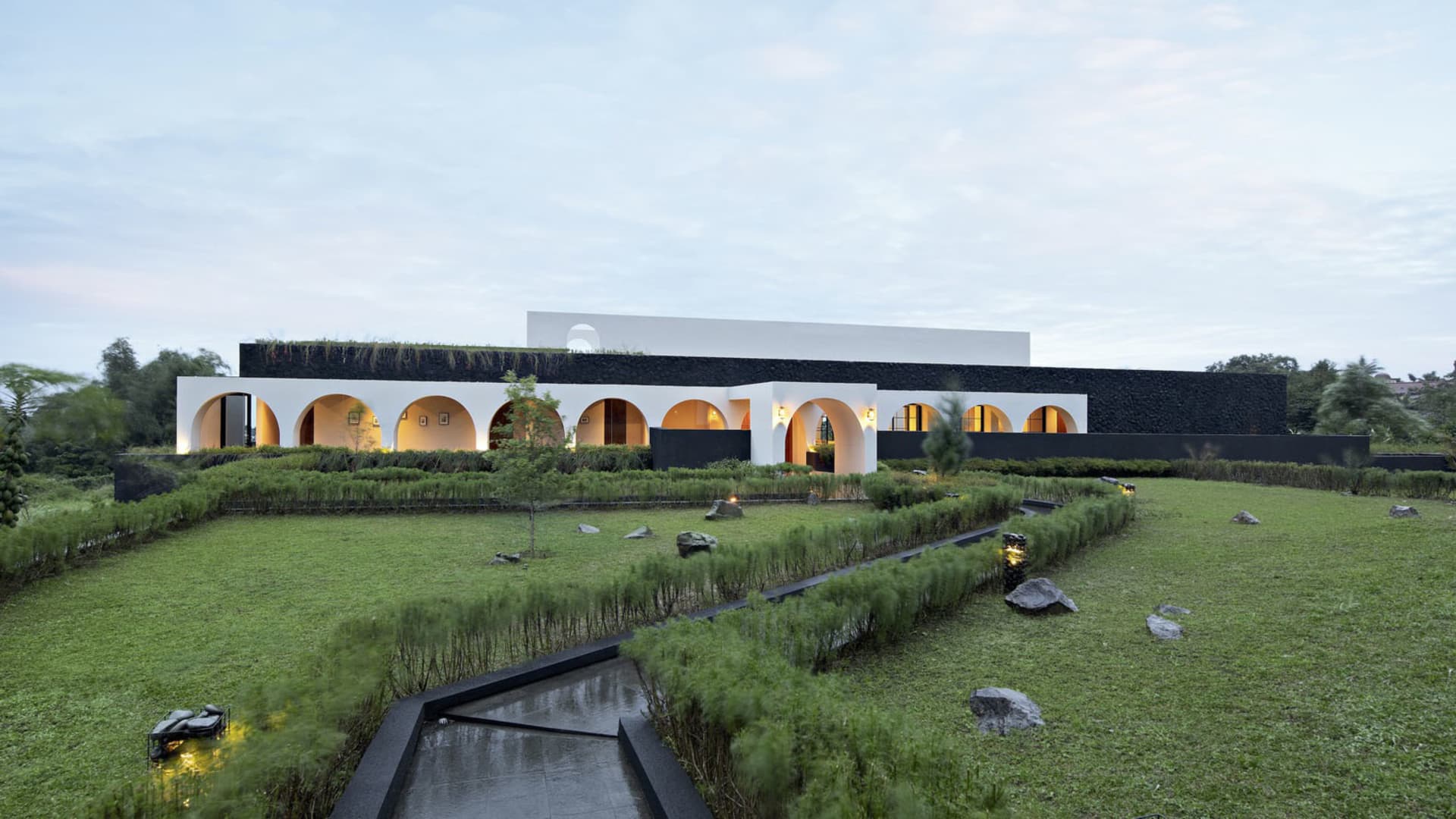 A contemporary residential building with modern concrete and glass design elements.