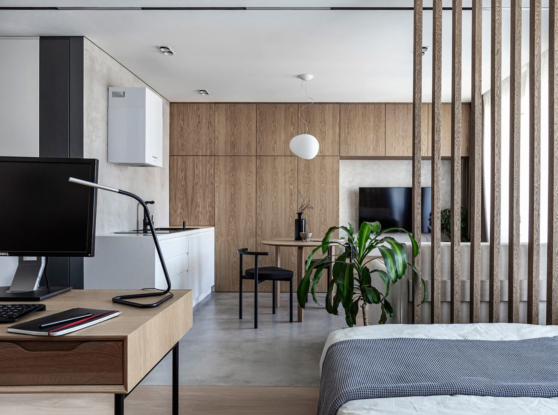 A modern residential space featuring minimalist design with wood, concrete, and metal materials.