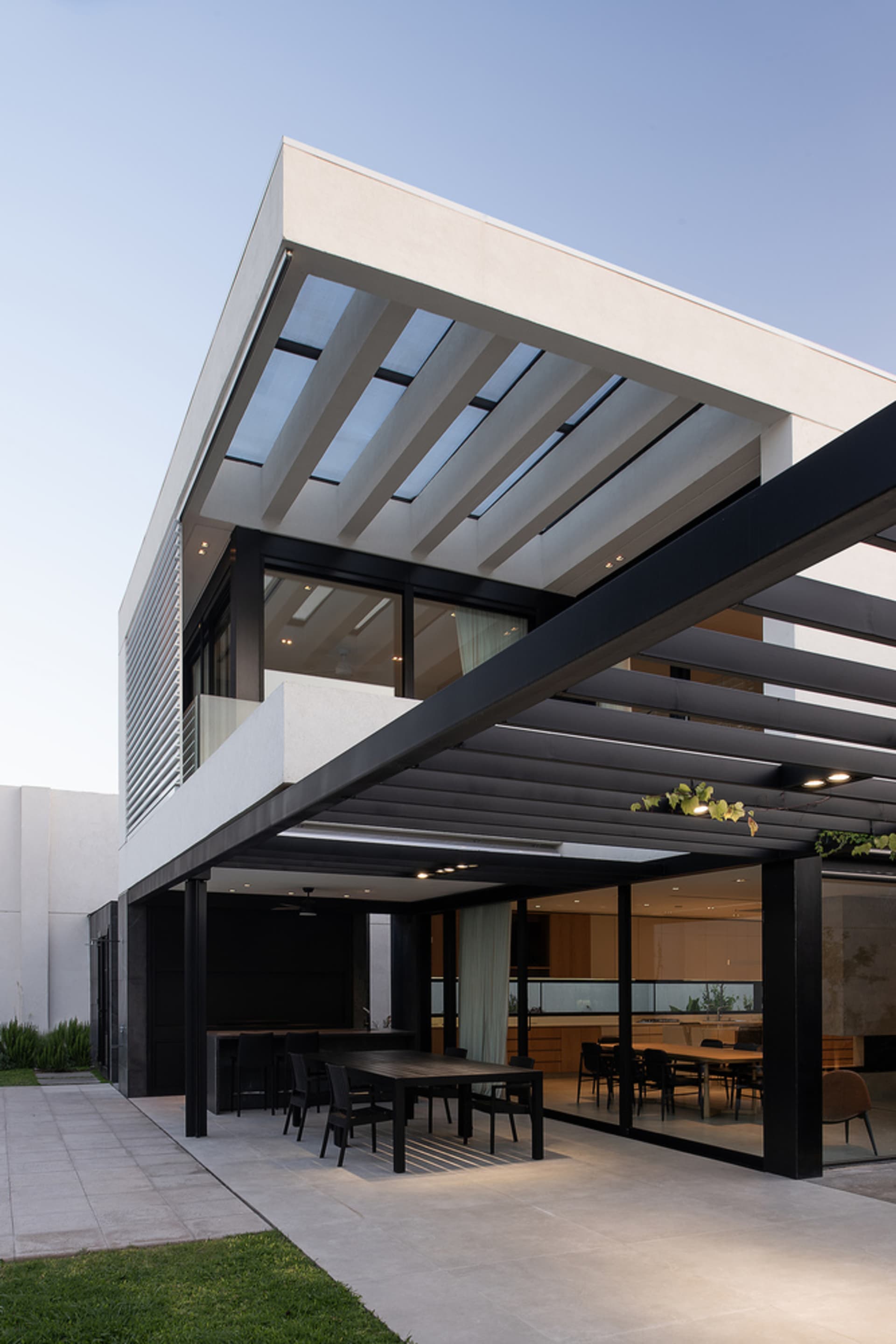 A modern residential exterior featuring concrete and glass materials.