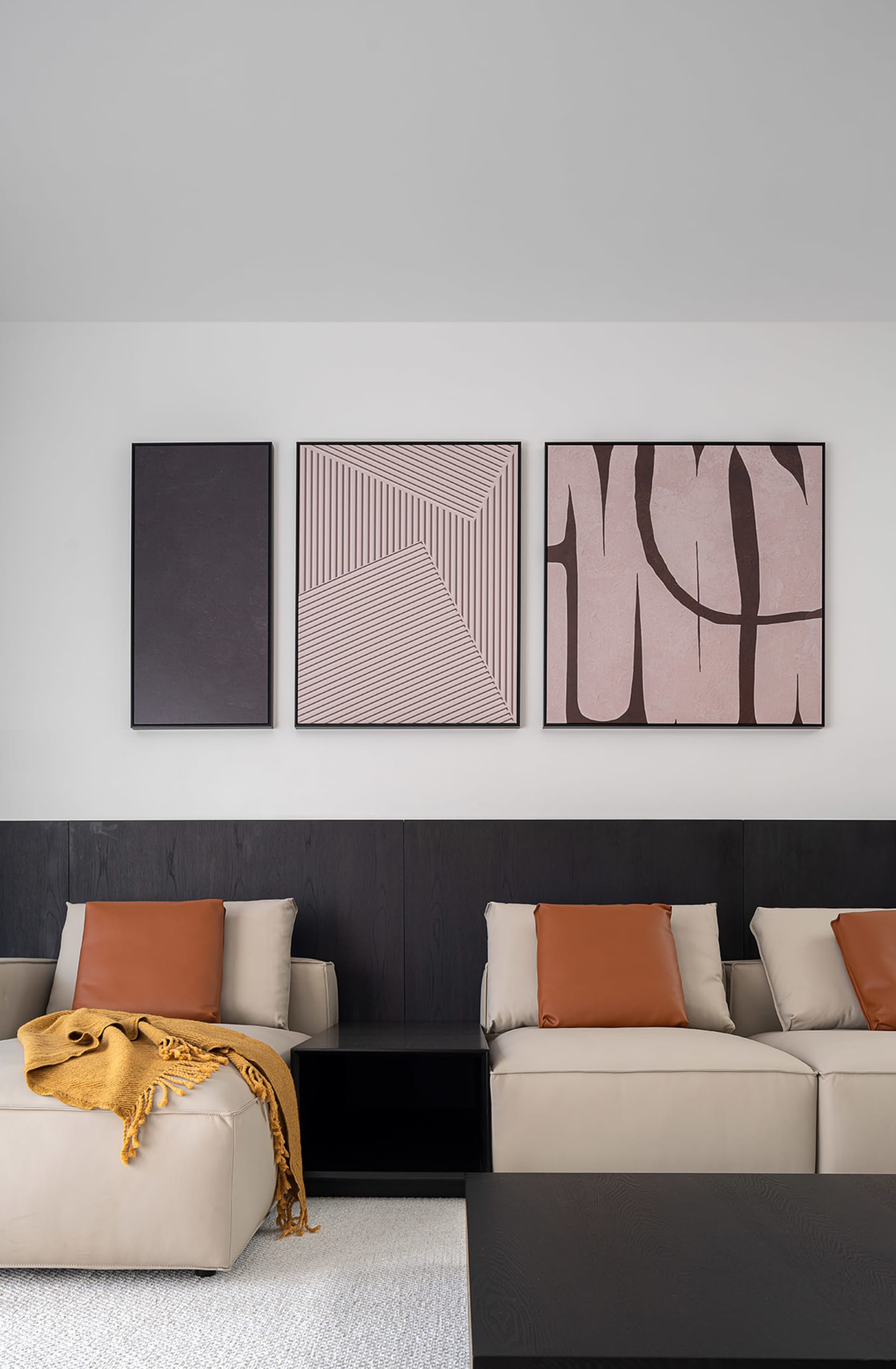 A modern living room featuring textured wall materials with contemporary art installations.
