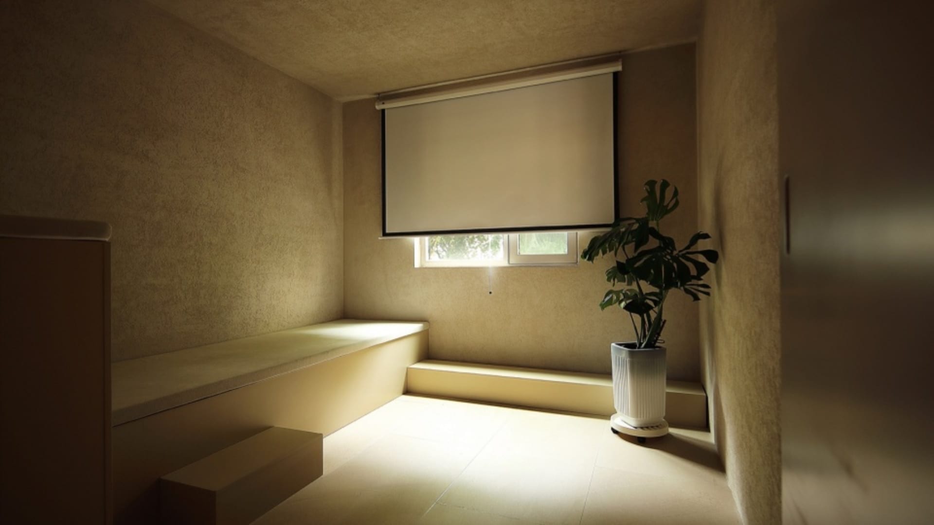 A modern, minimalist living room with concrete walls and floor.