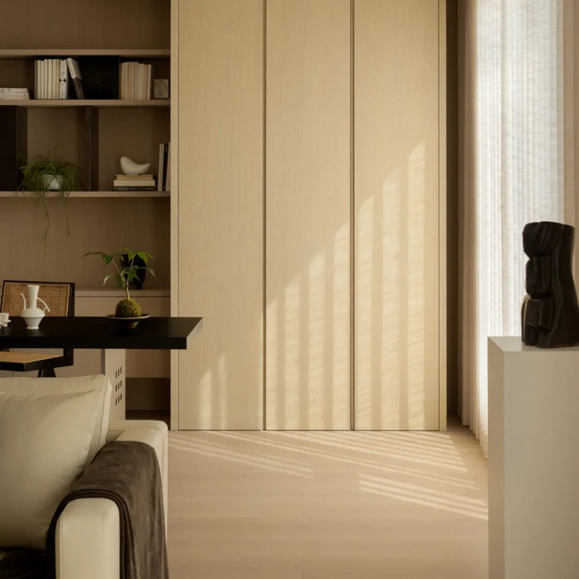 Cozy minimalist living room featuring wood furniture, leather accents, and glass windows.