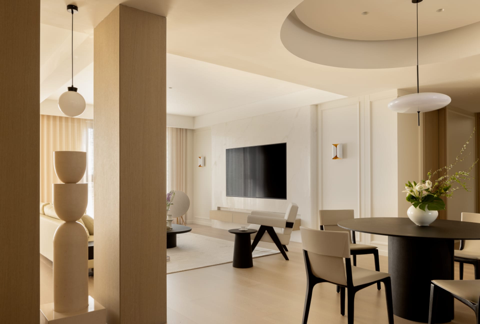Contemporary living room with minimalist design, featuring a white marble floor, white marble coffee table, and white seating